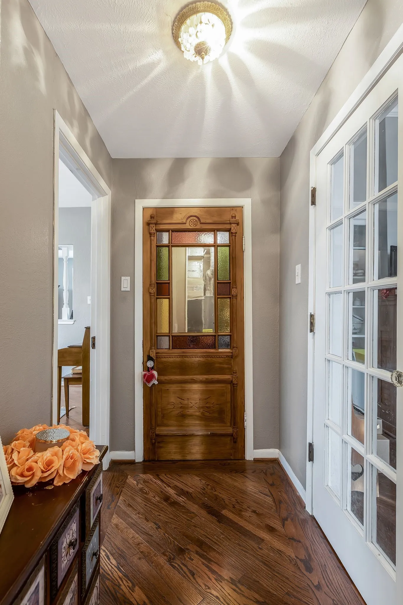 Beautiful stained glass door leading to storage galore for overflow groceries, large appliances, and more!