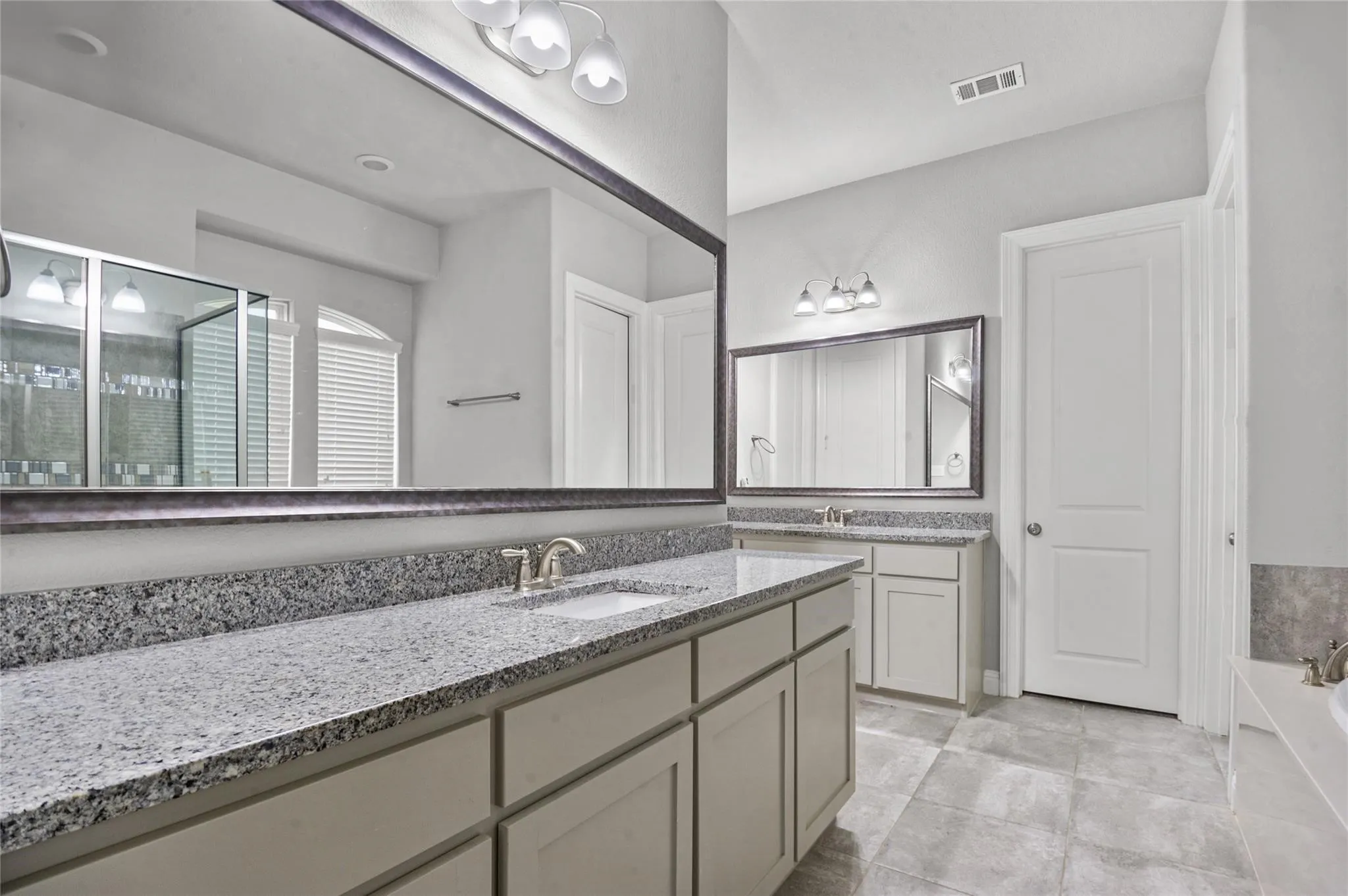 Bathroom with vanity, a bath, and a stall shower