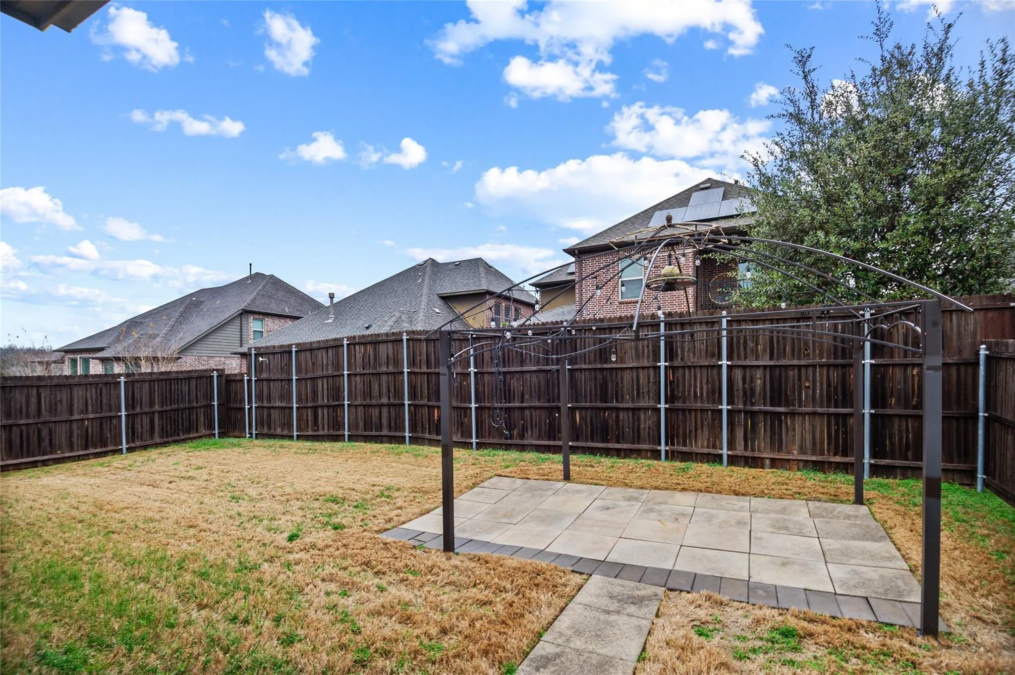 Fenced backyard with a patio area