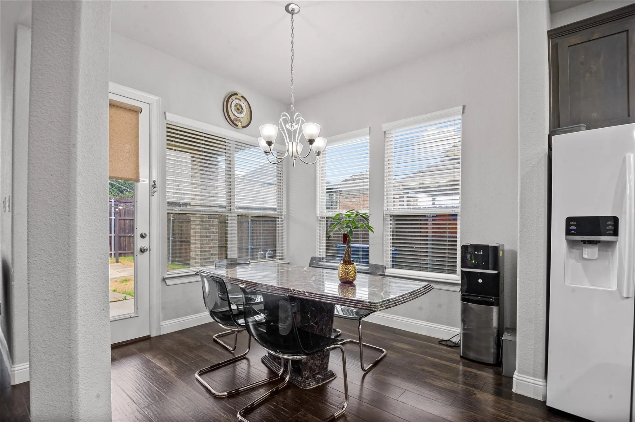 Dining room featuring dark wood finished floors and suspended lighting