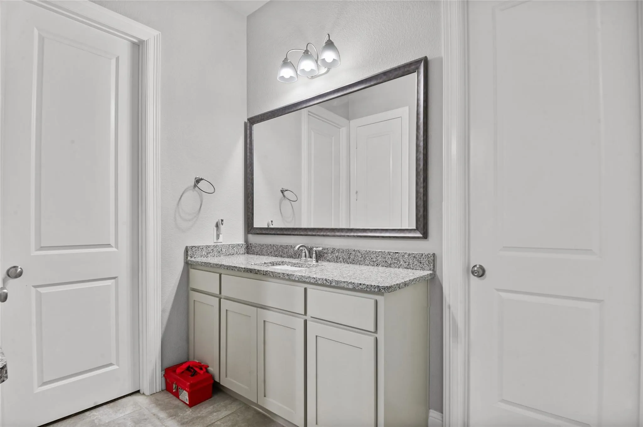 Bathroom featuring vanity and a textured wall