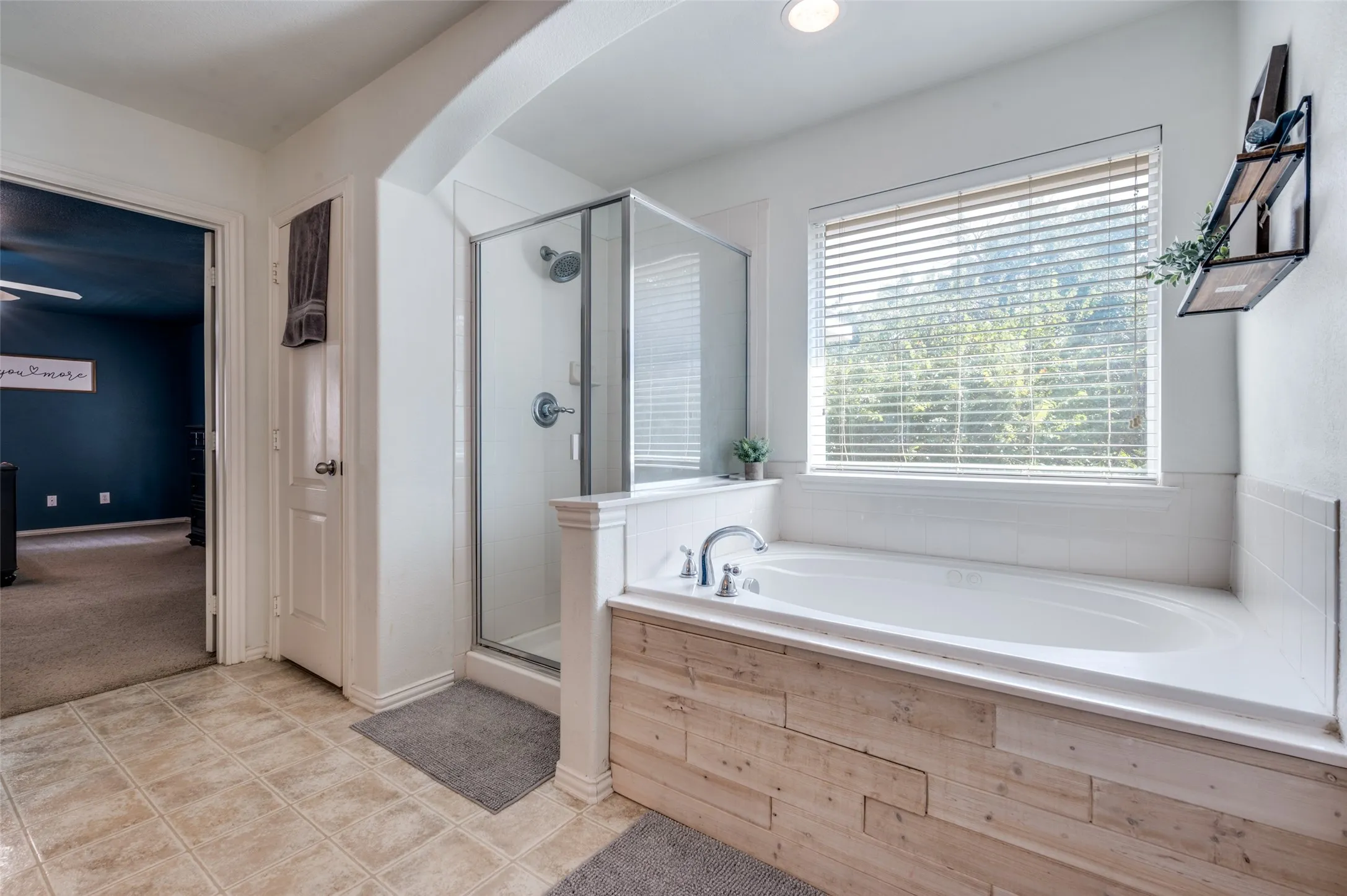 Relaxing primary bathroom offer separate shower and garden tub.