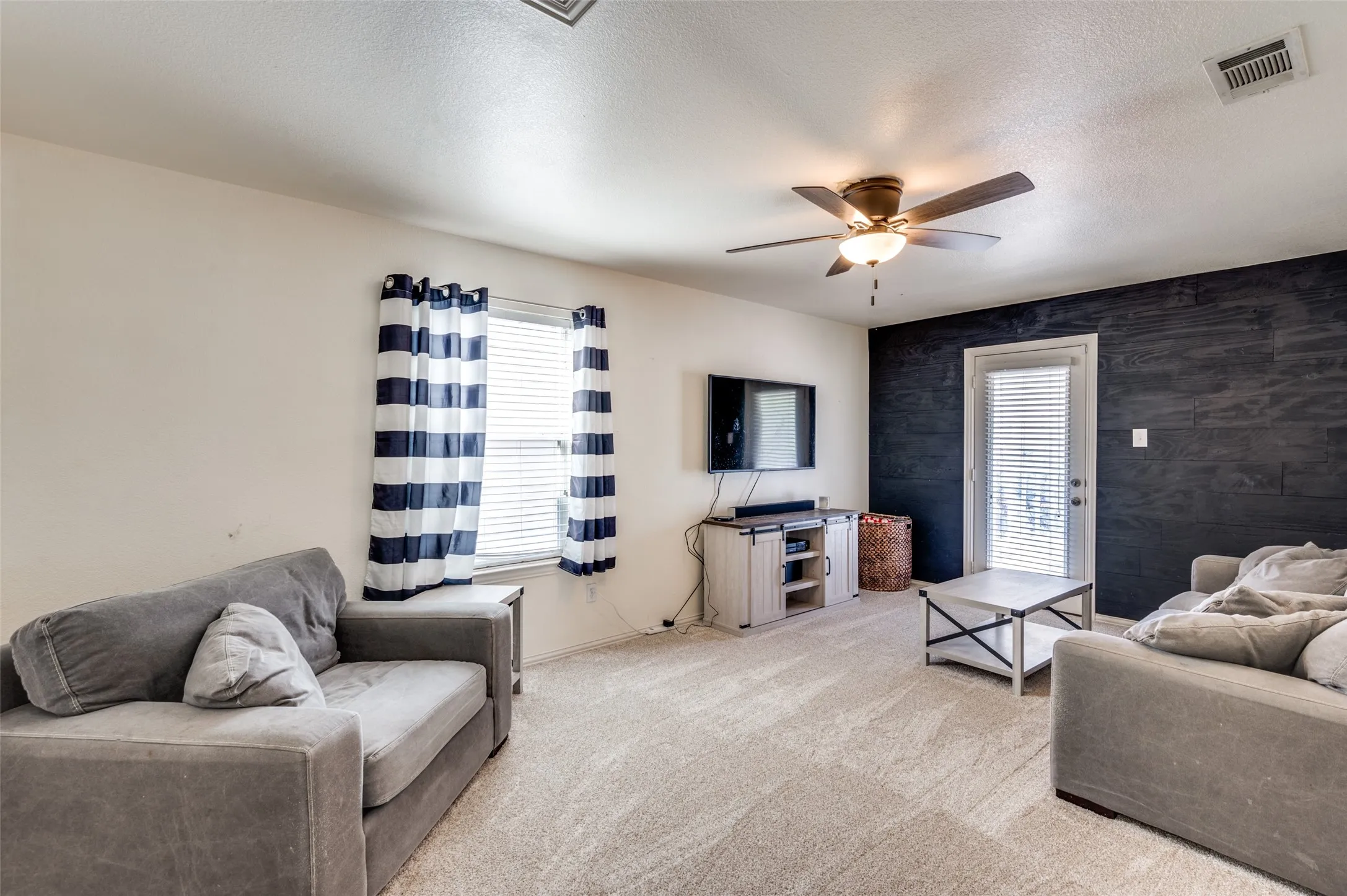 Game room or second living located upstairs with direct access to the exterior balcony overlooking the backyard.