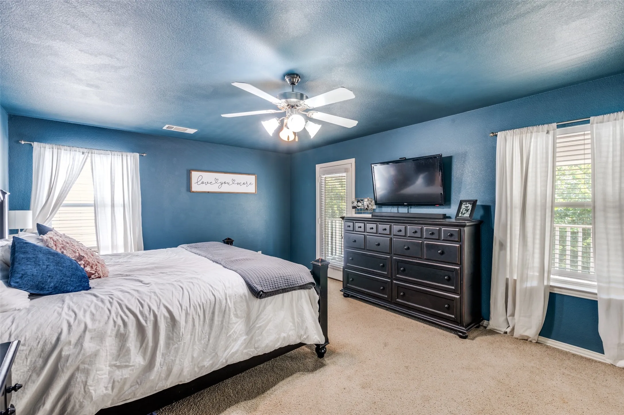 This primary suite is a must see, large enough for a sitting area.