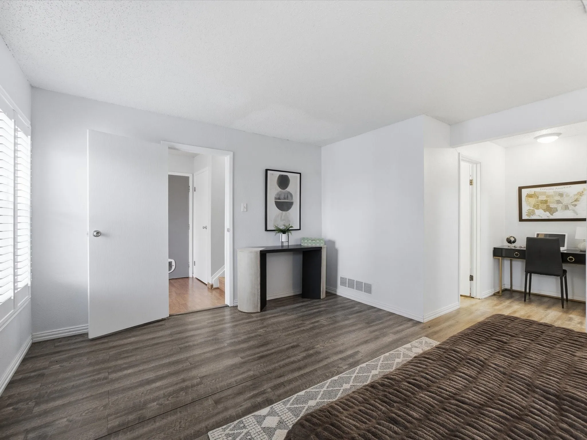 Primary Bedroom featuring a textured ceiling and dark wood-style floors