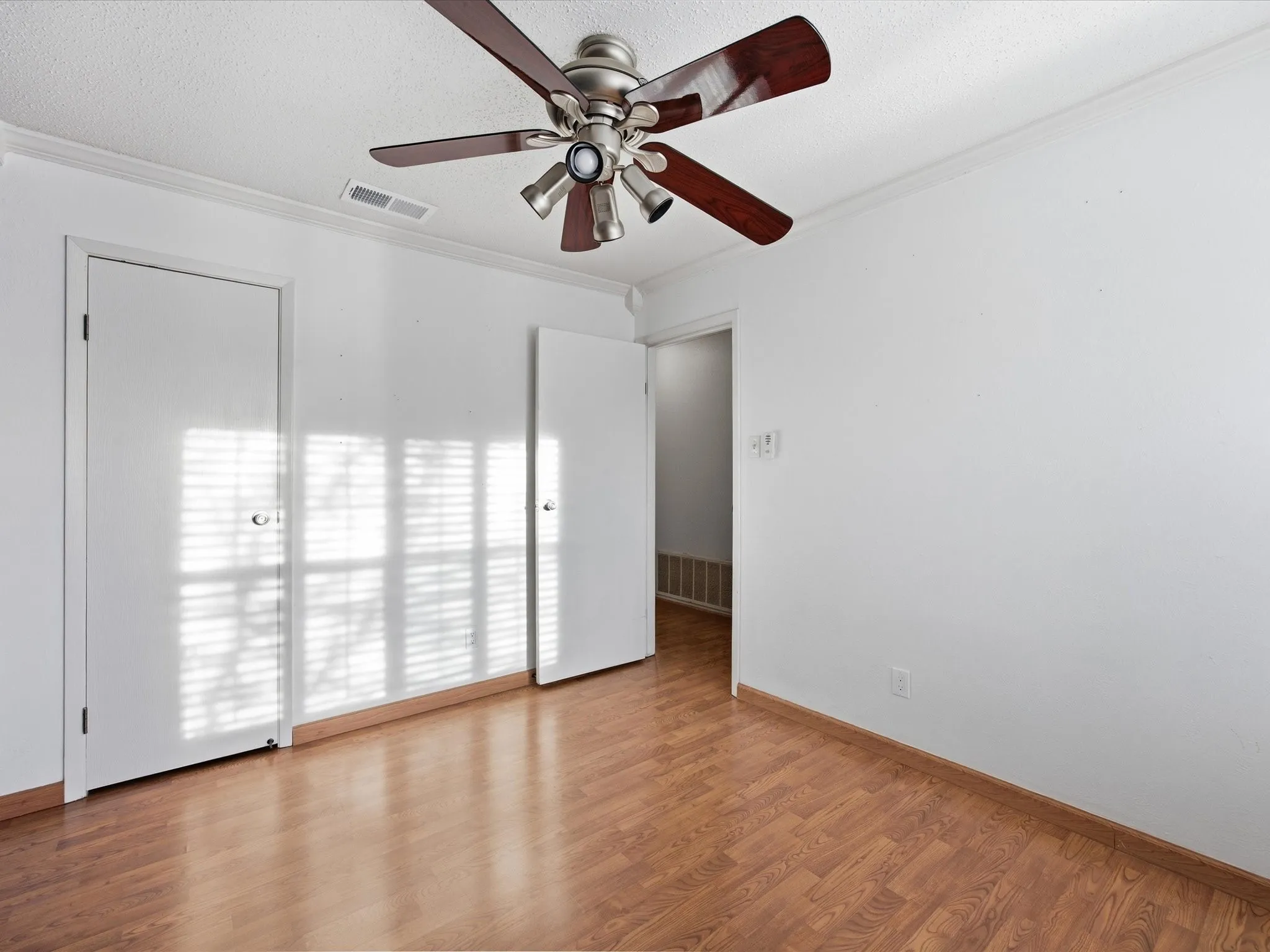 Bedroom with light wood-style floors and ceiling fan