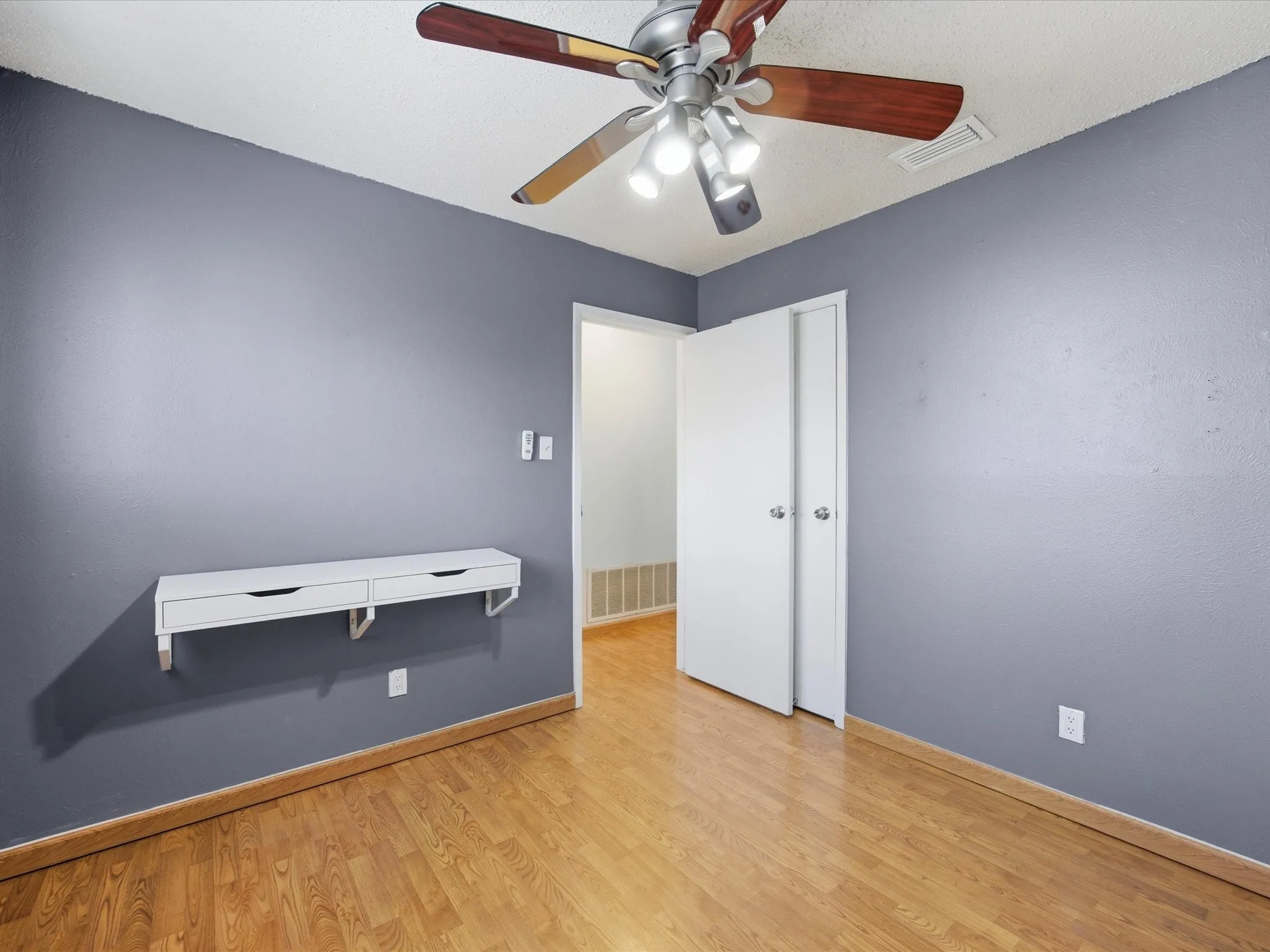 Bedroom with light wood-style floors and ceiling fan