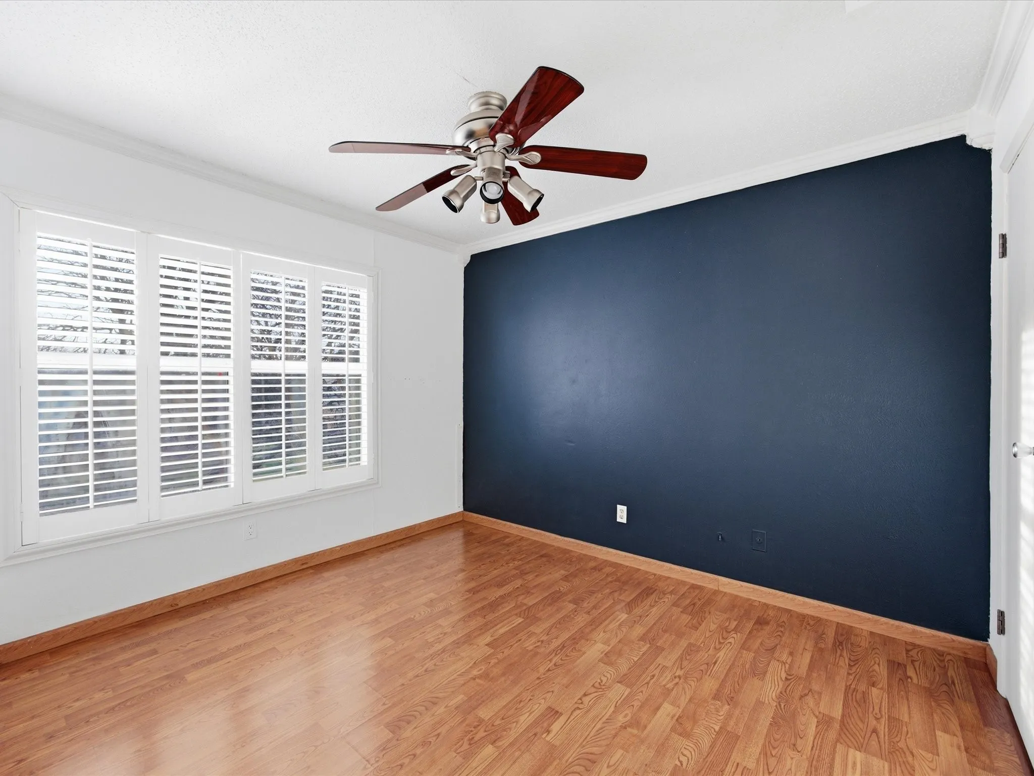 Bedroom with light wood-style floors and ceiling fan