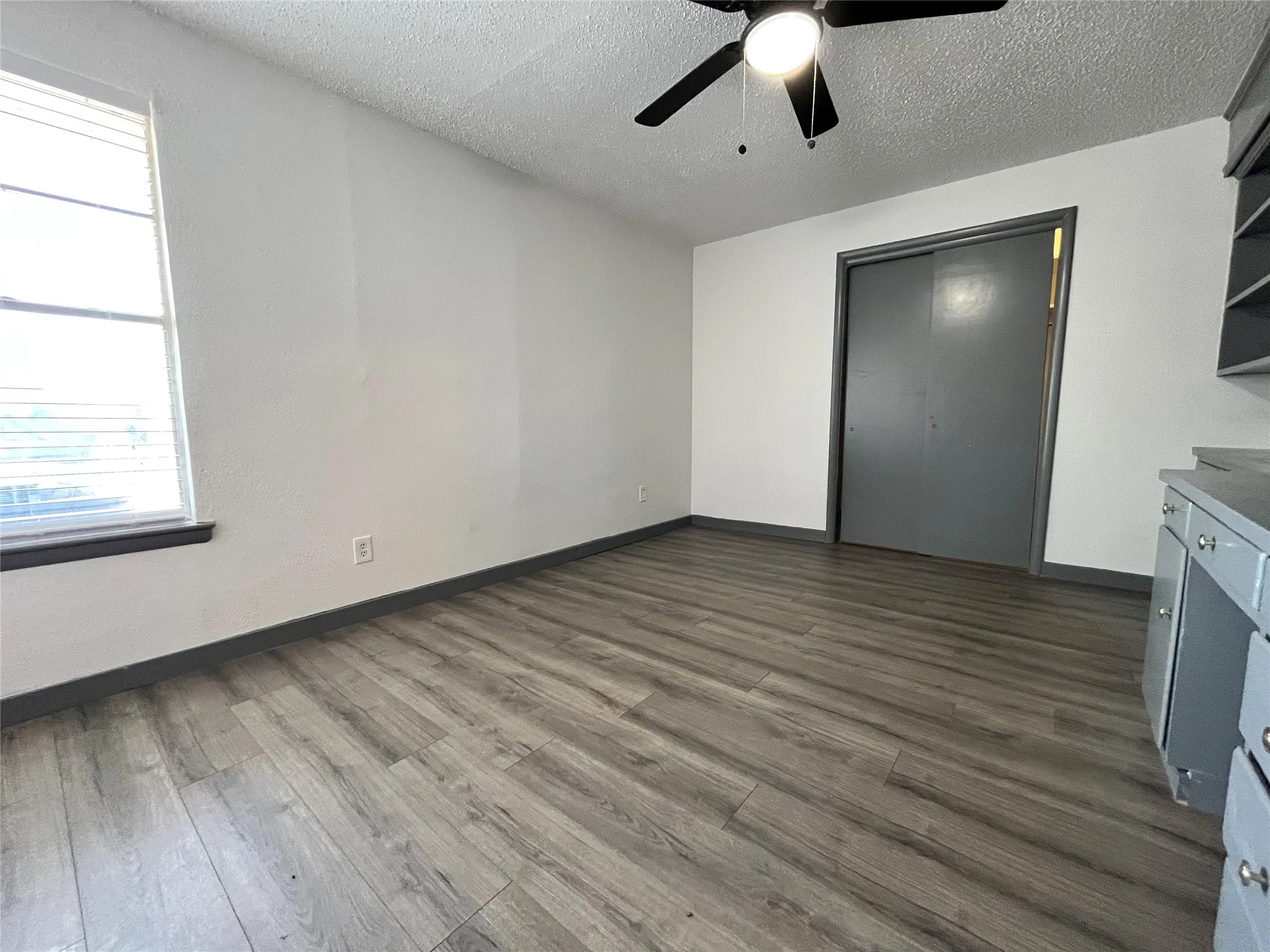 This is a view of the master bedroom, partnered with a walk-in closet. Notice the new flooring.