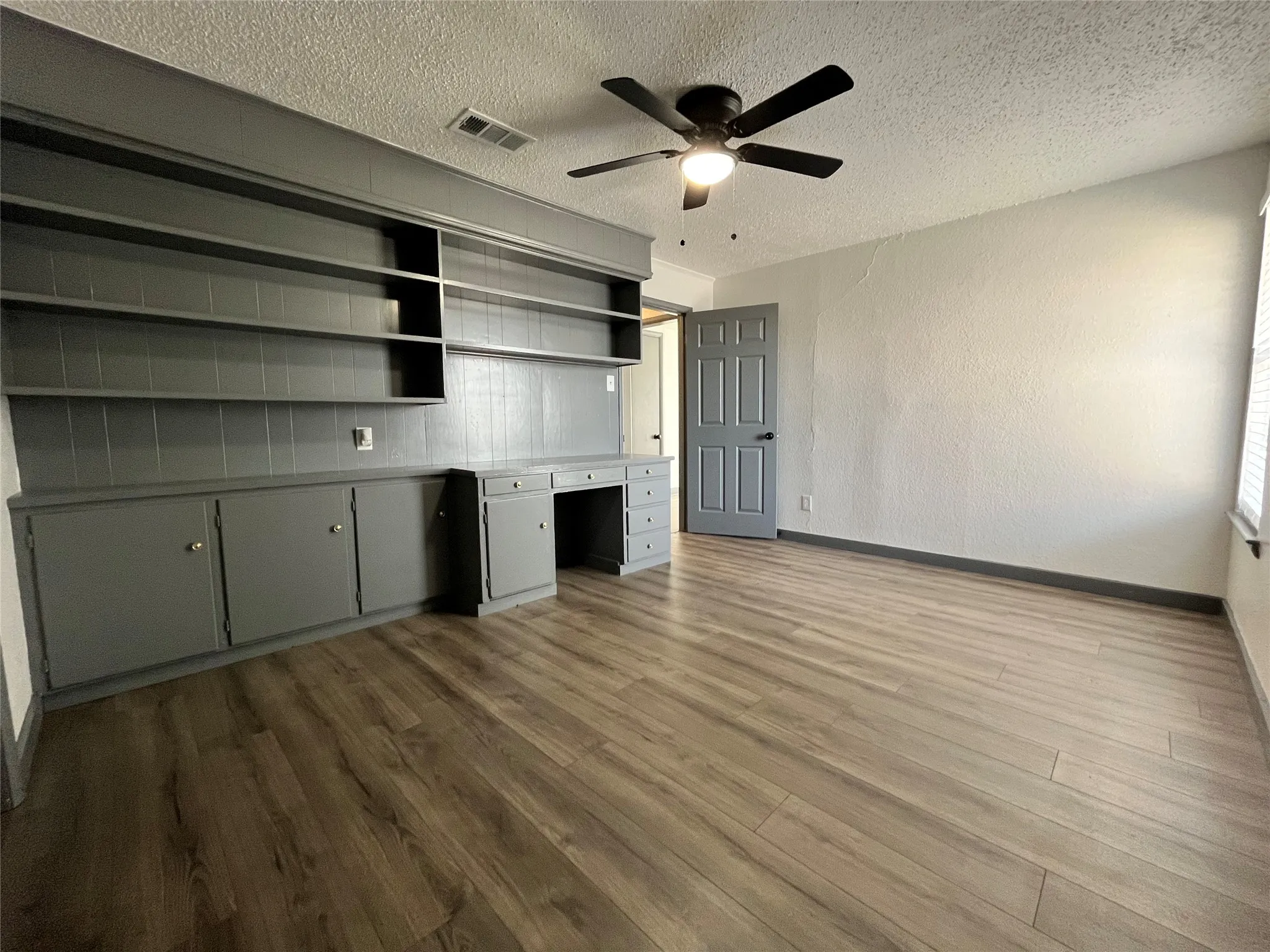 This is a view of the master which is also equipped with this large media center. This space could be used for a bedroom, an office, a library, for media staging, or for any combination of these things.