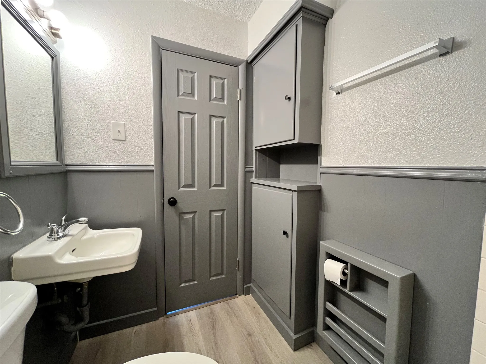 This bathroom is also equipped with a built-in linen cabinet.