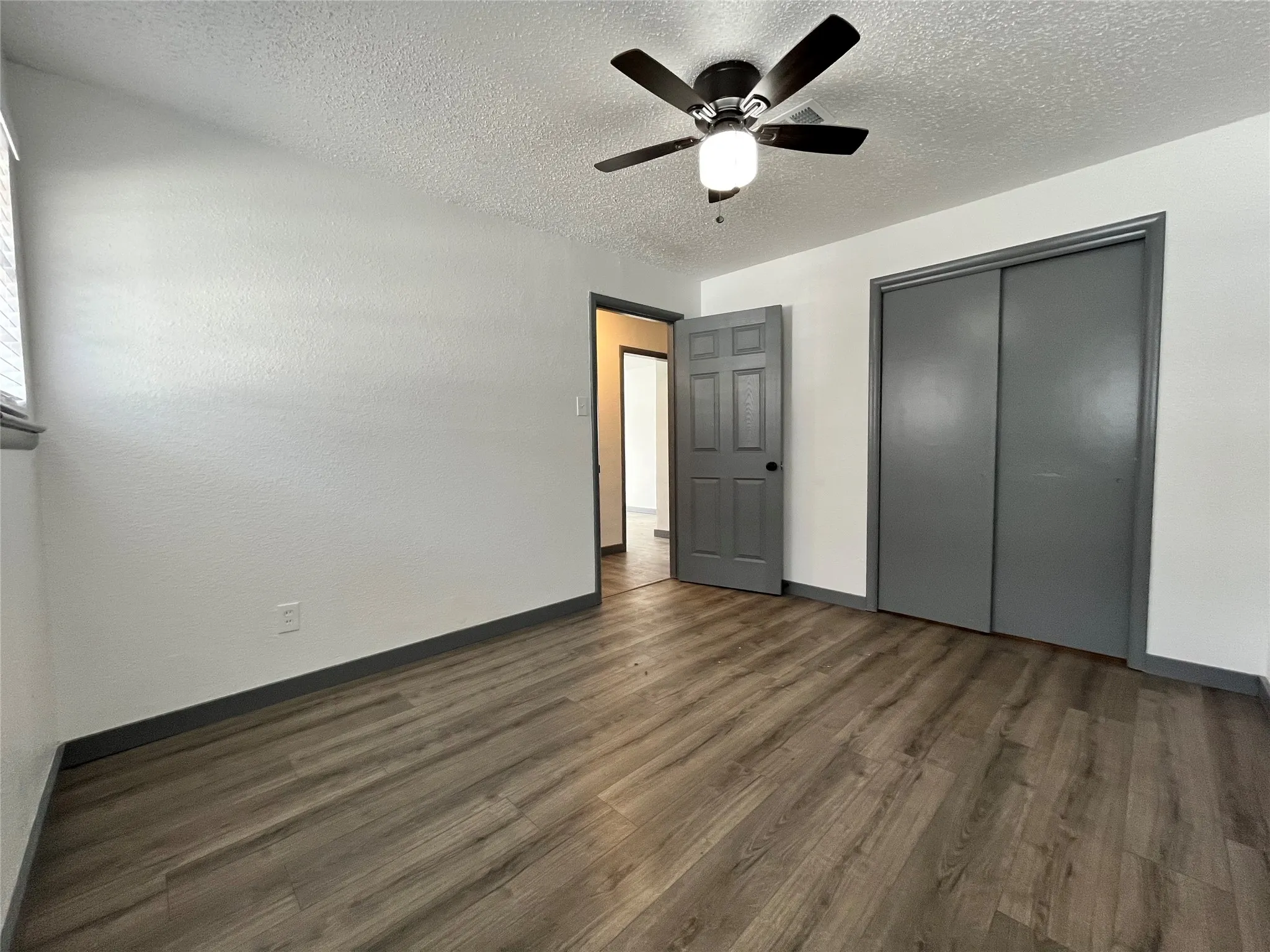 Here is another view of the bedroom, portraying the light from the windows and the sliding closet door.