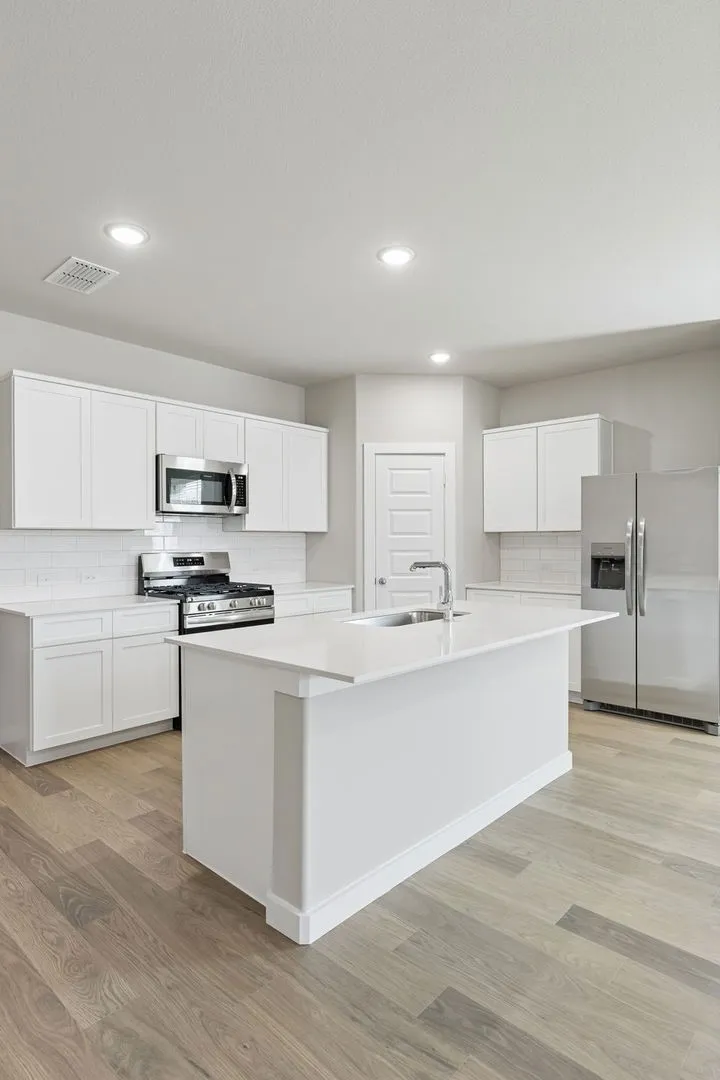 Kitchen in the Holden home plan by Trophy Signature Homes – REPRESENTATIVE PHOTO