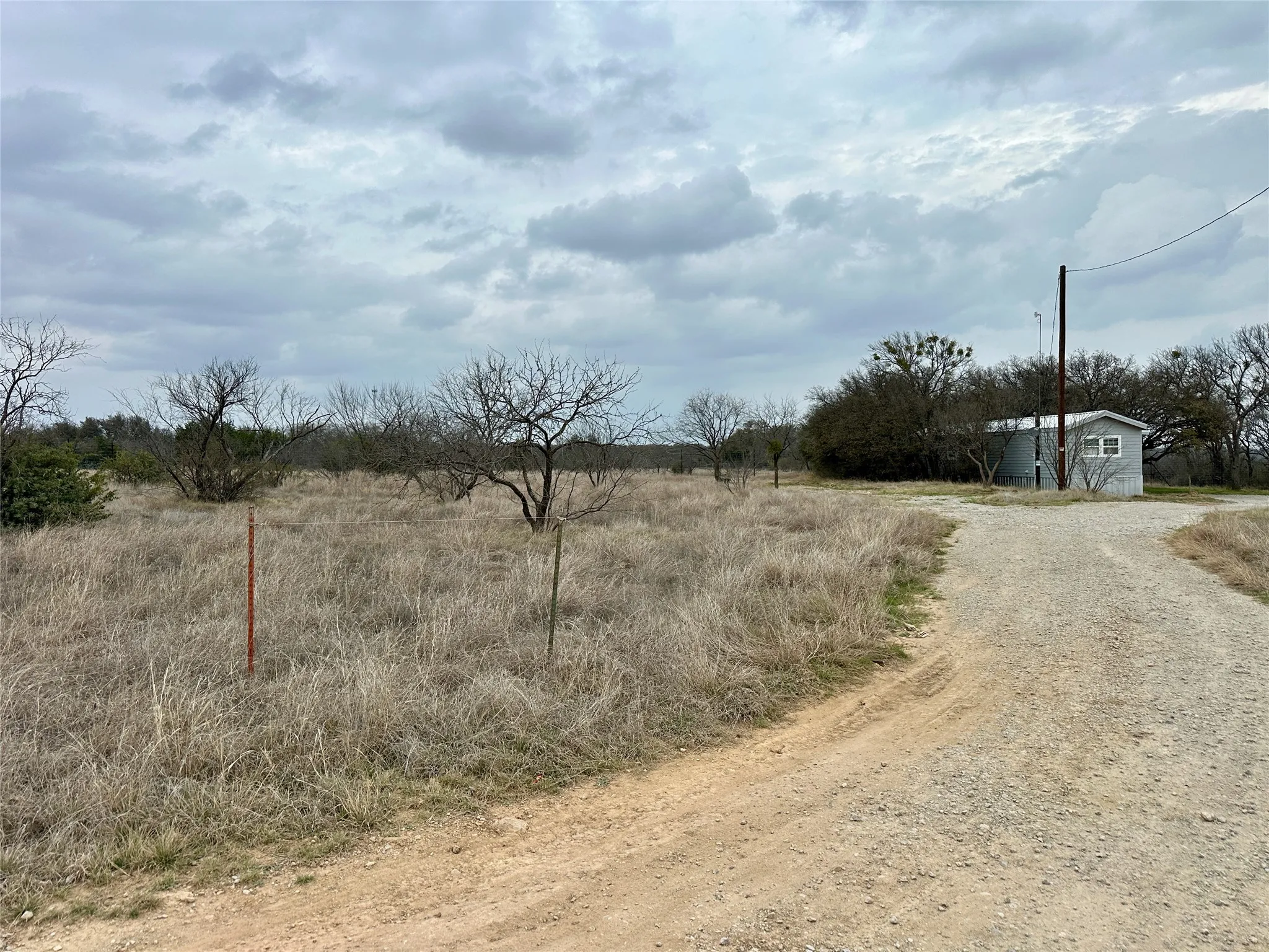 View of dirt / gravel driveway featuring a view of countryside