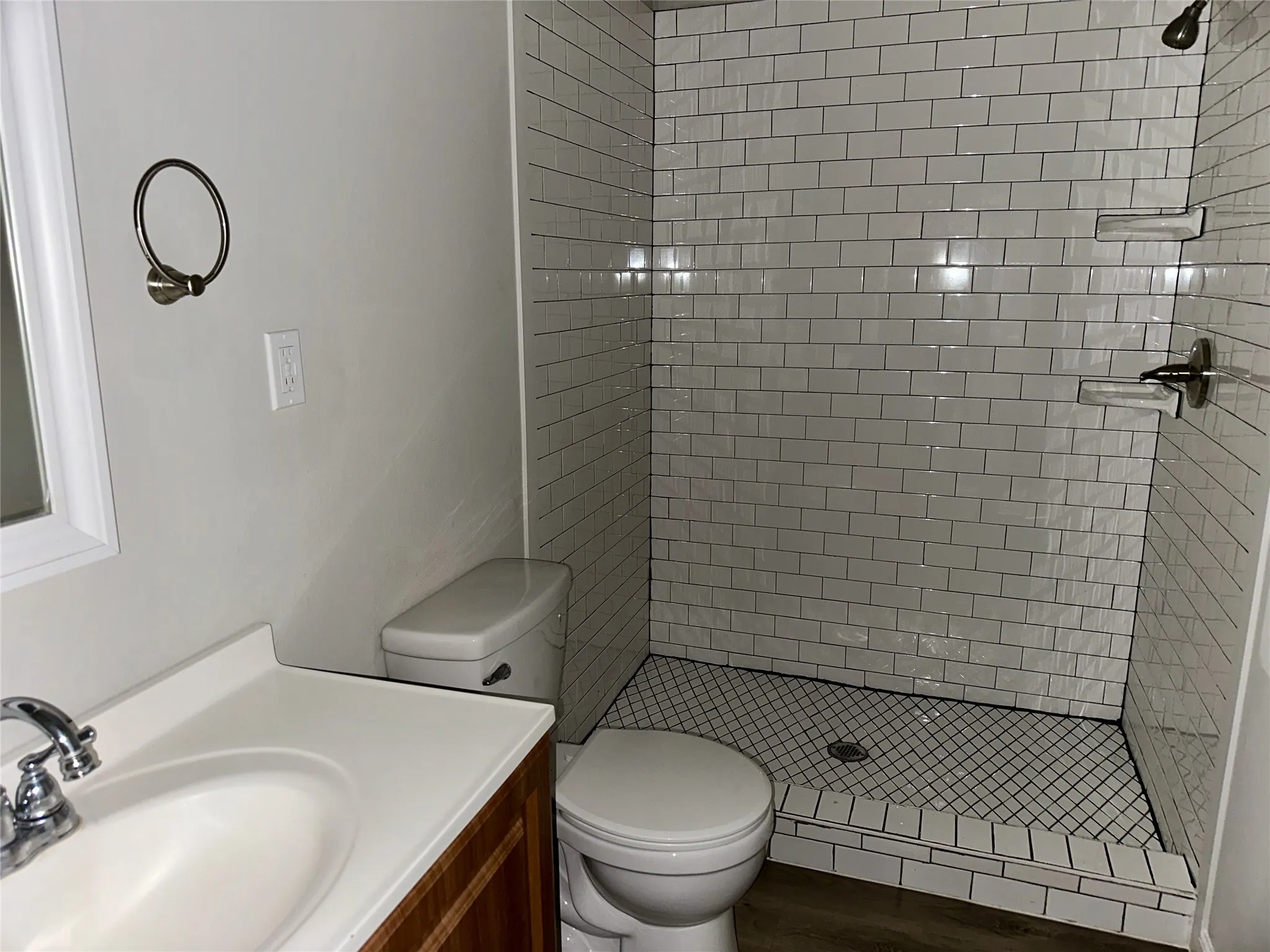 Full bathroom featuring vanity, a stall shower, and wood finished floors