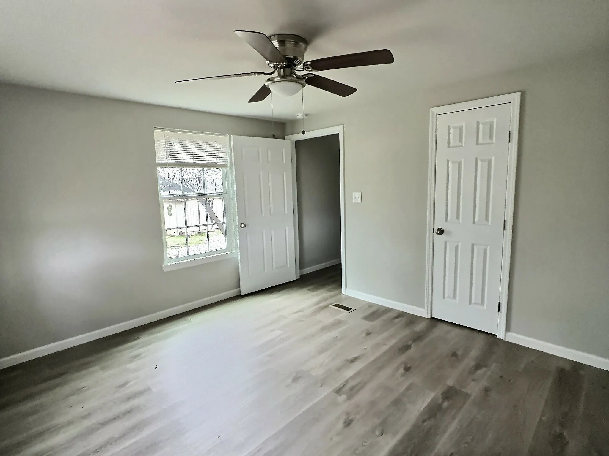 Unfurnished bedroom featuring light wood-style floors and a ceiling fan