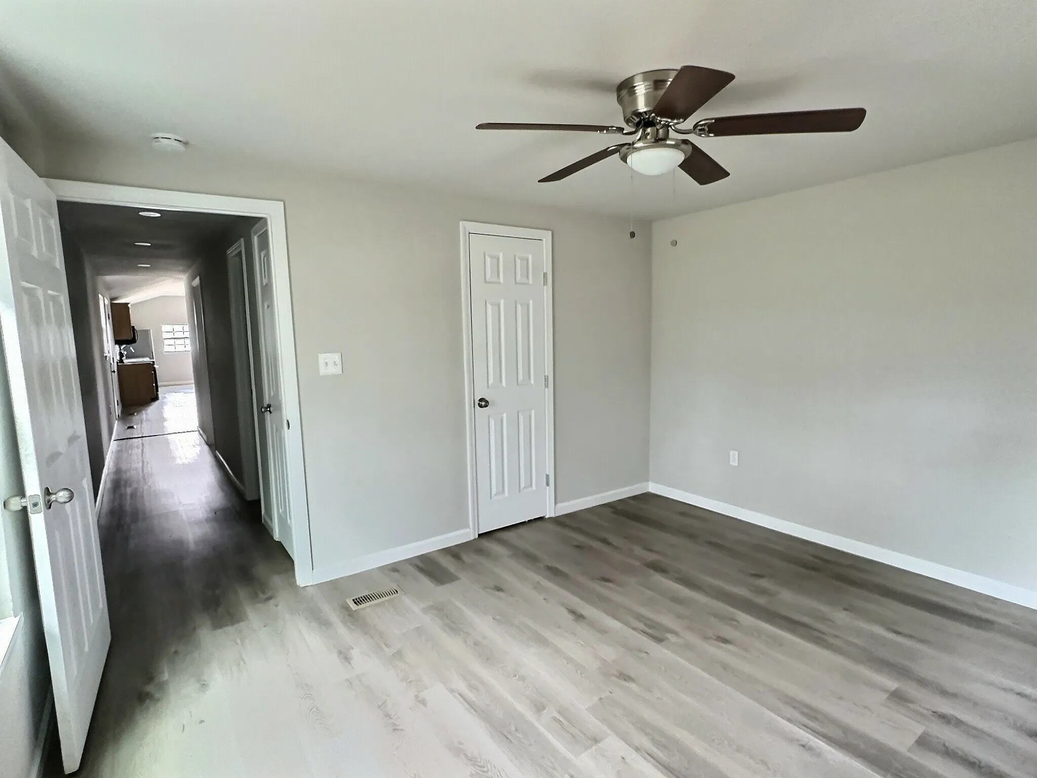 Unfurnished bedroom with a closet, light wood finished floors, and ceiling fan