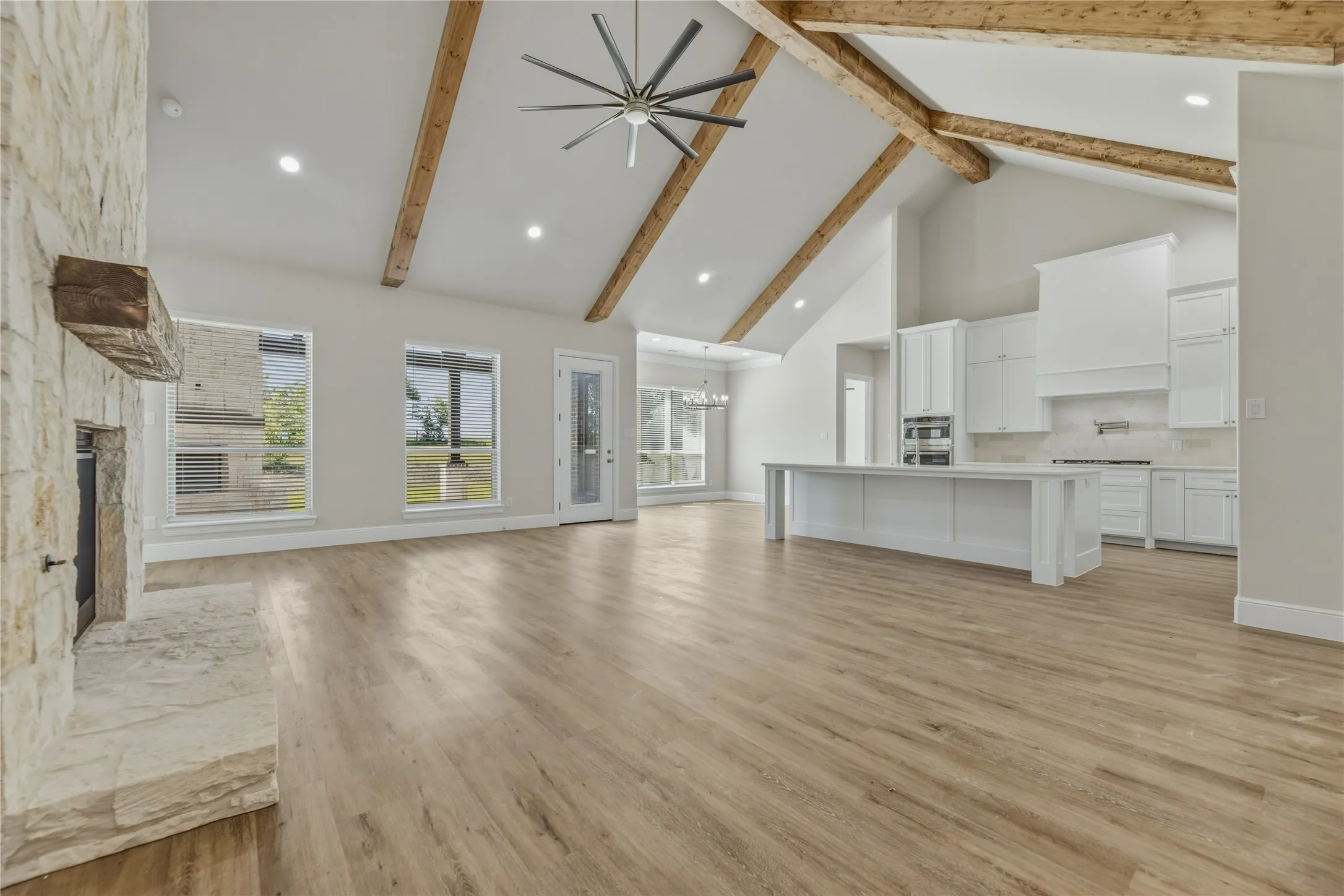 Beautiful luxury vinyl wood plank and vaulted ceiling. Spacious kitchen
