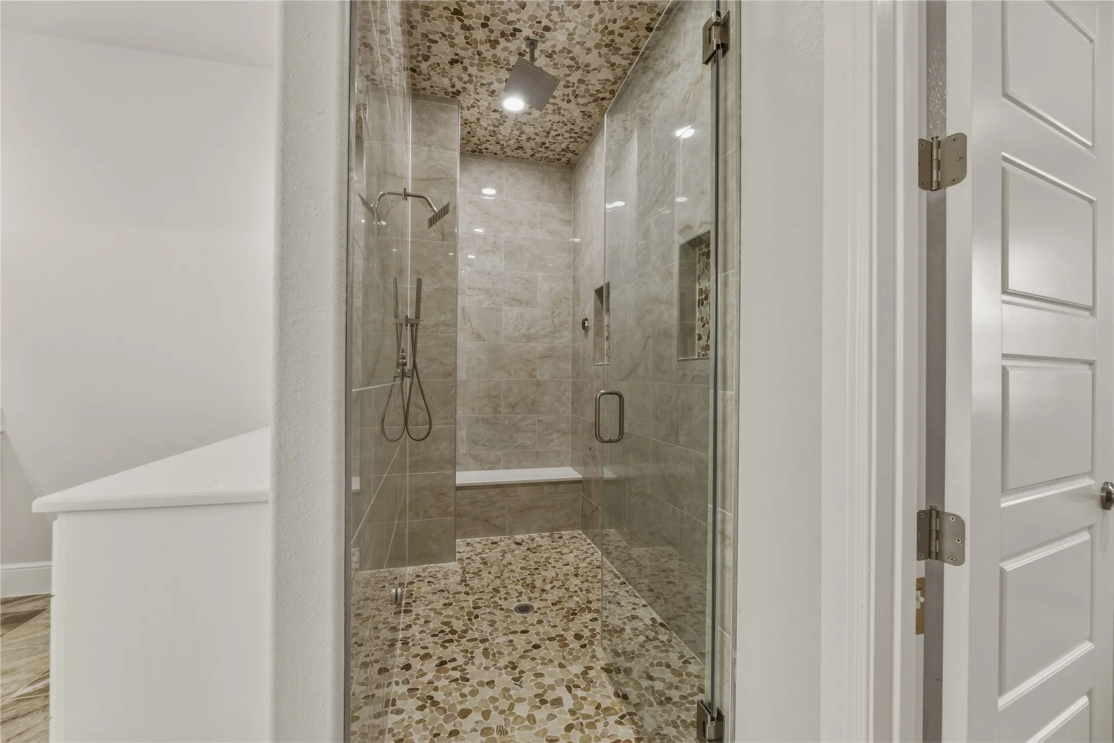 Double shower with sitting area plus a steam shower