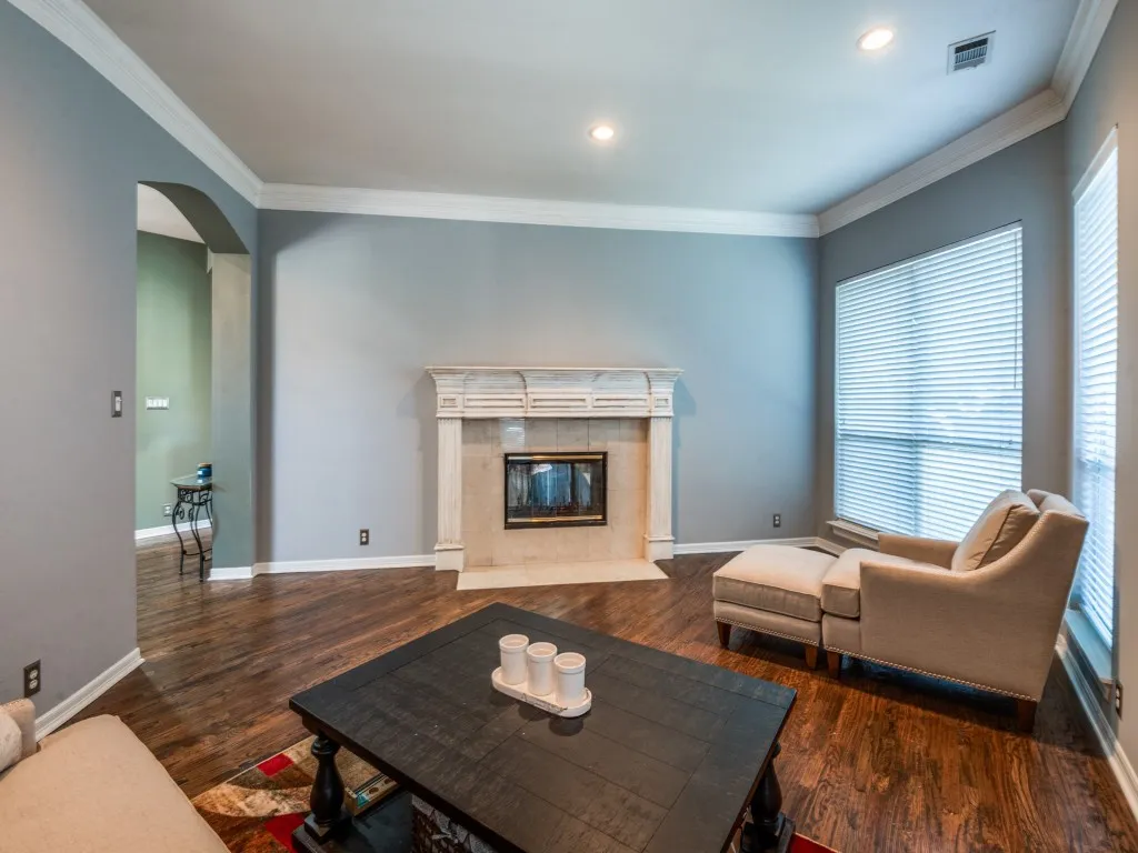 second living space with shared fireplace, has been painted beige.