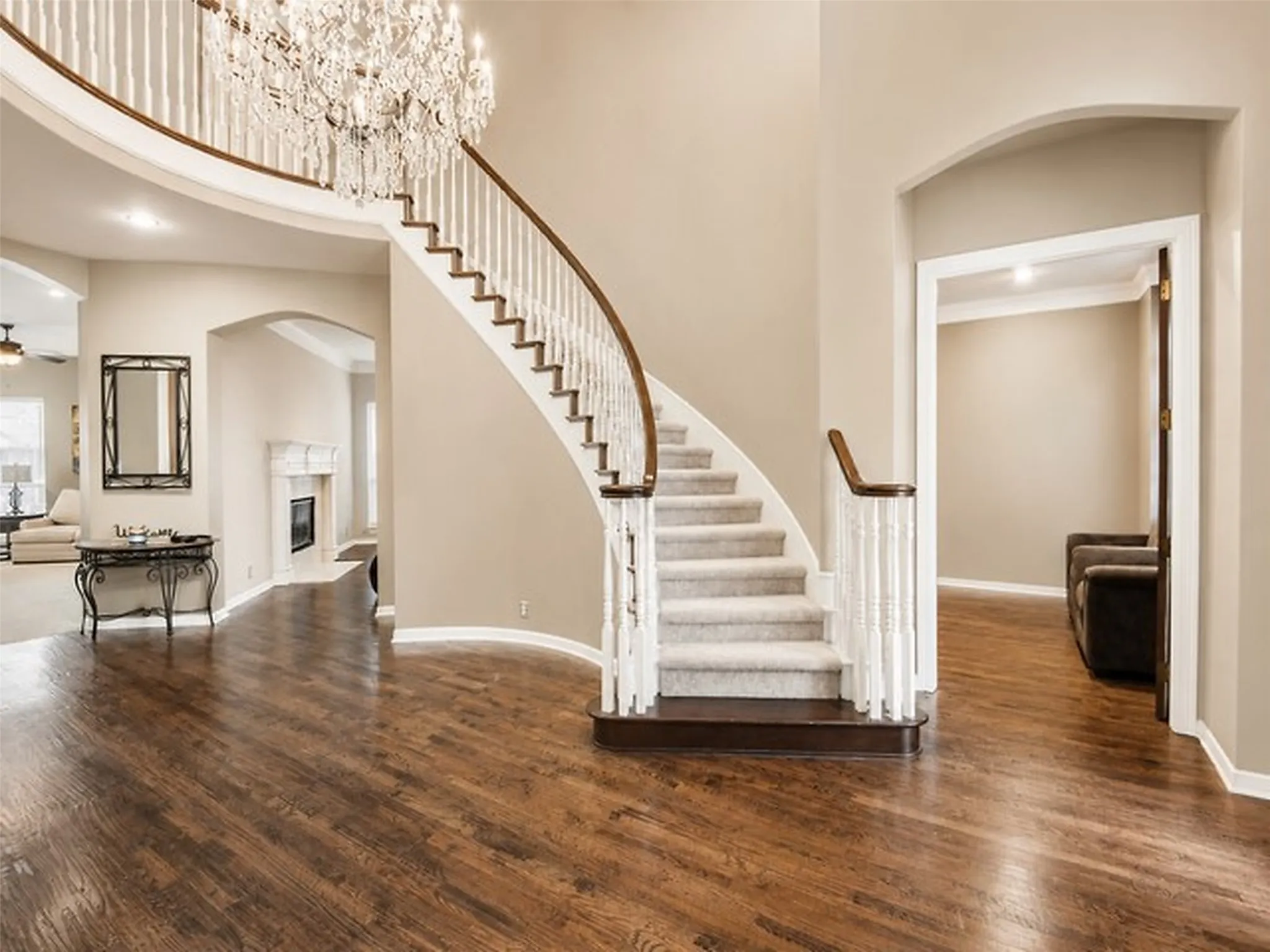 GRAND entrance freshly painted beige walls and white spindles.