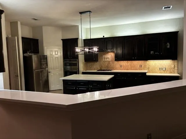 New Quartz counter tops, New light fixture and beige paint!