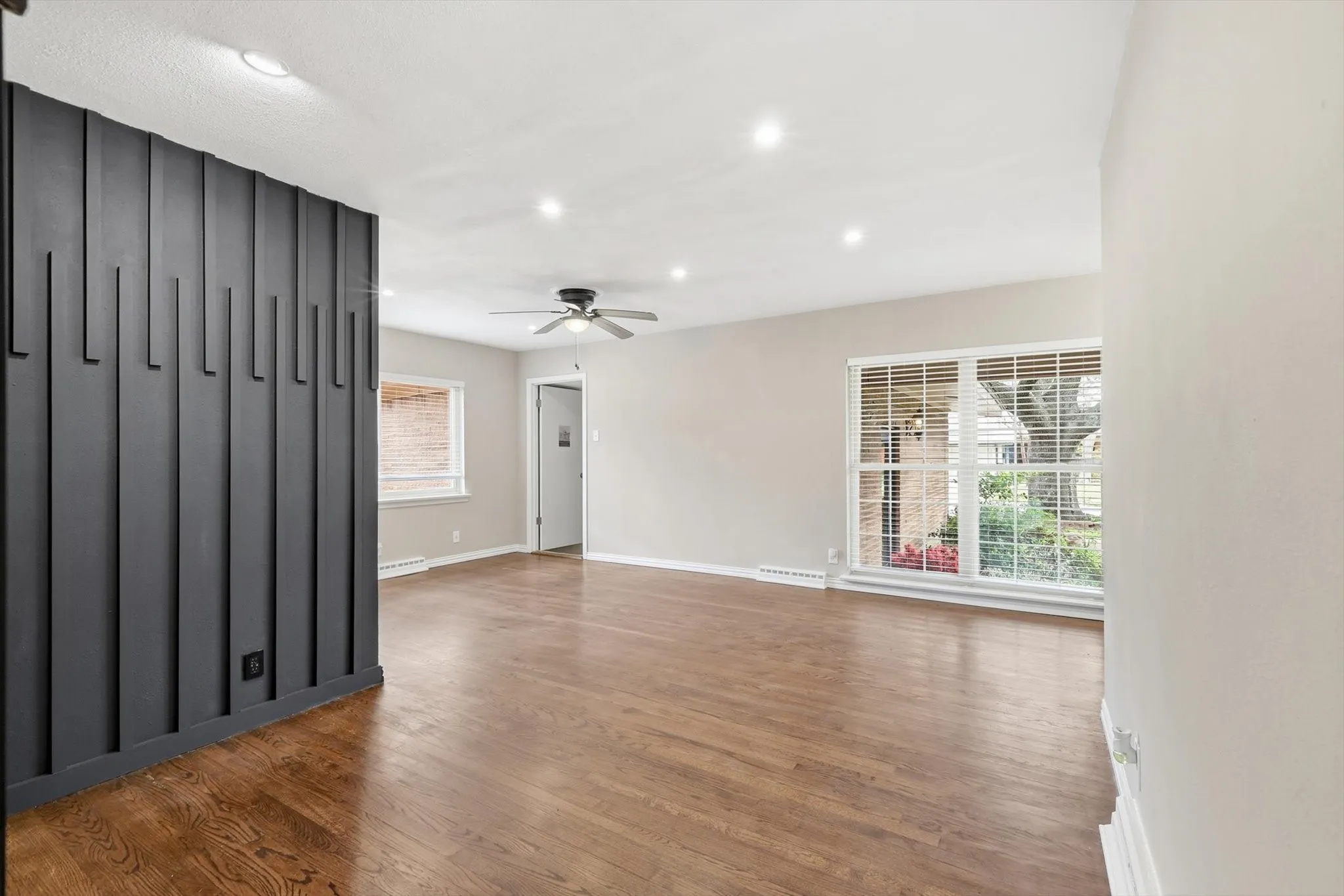 Spare room with dark wood finished floors, recessed lighting, ceiling fan, and baseboard heating