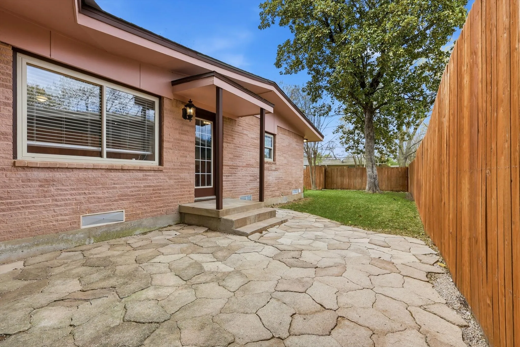 Fenced backyard with a patio area