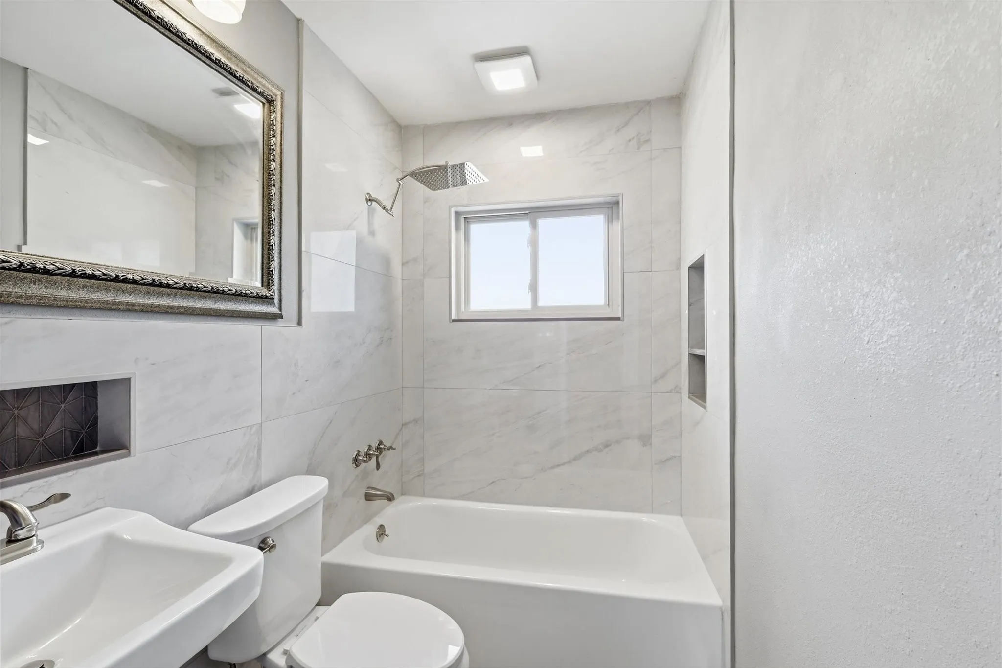 Full bath with  shower combination, a textured wall, and tile walls