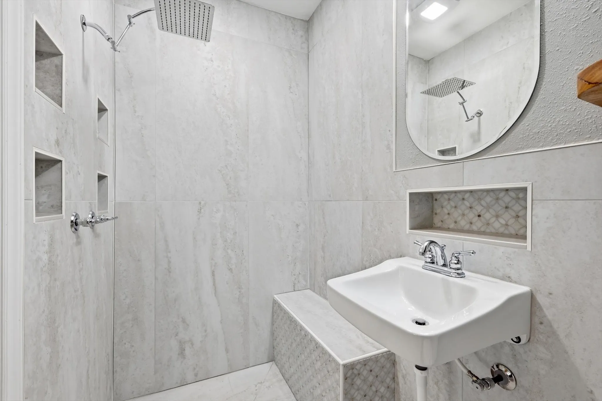 Full bath featuring a marble finish shower and tile walls