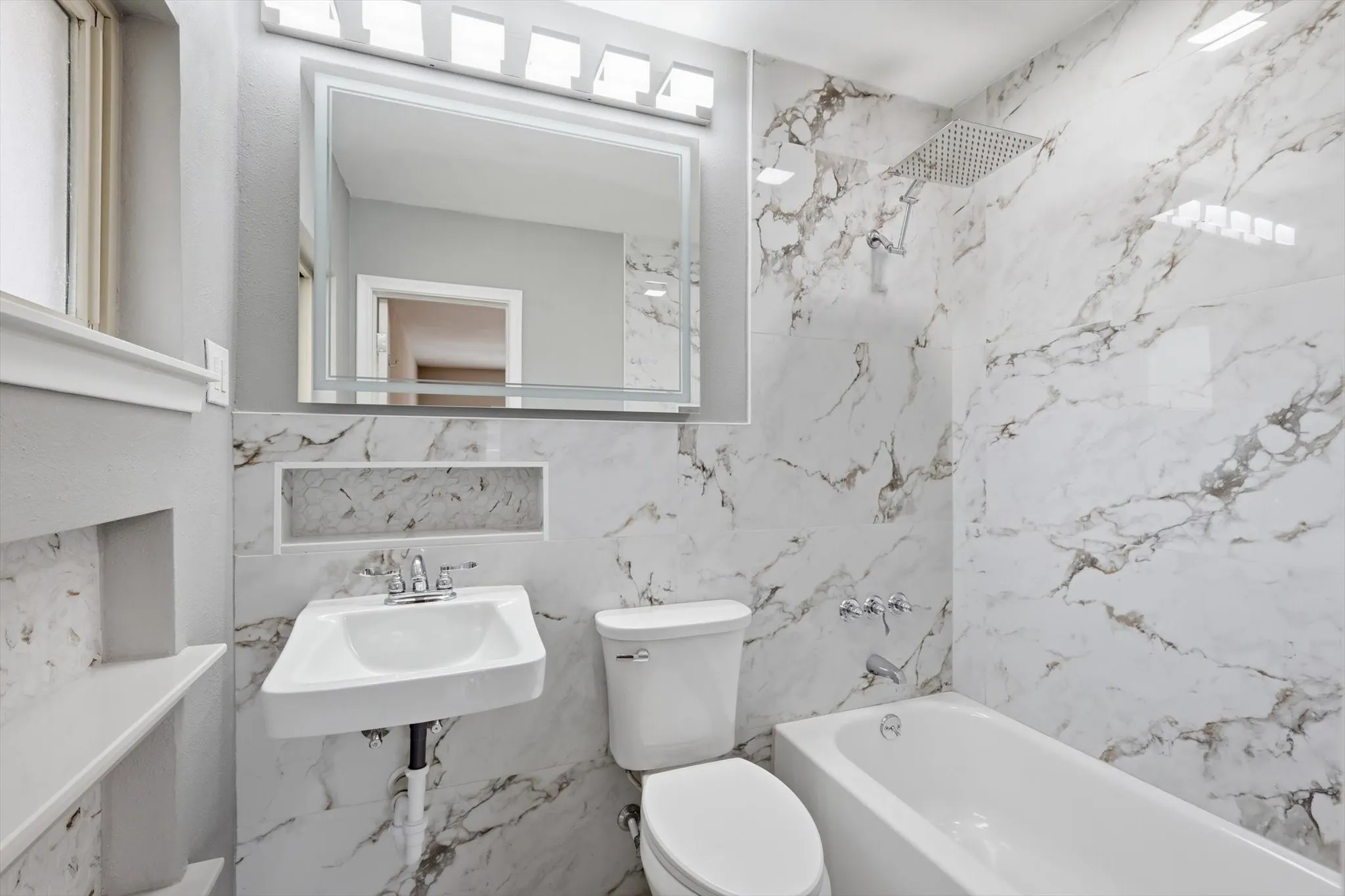 Full bath with tile walls and tub / shower combination