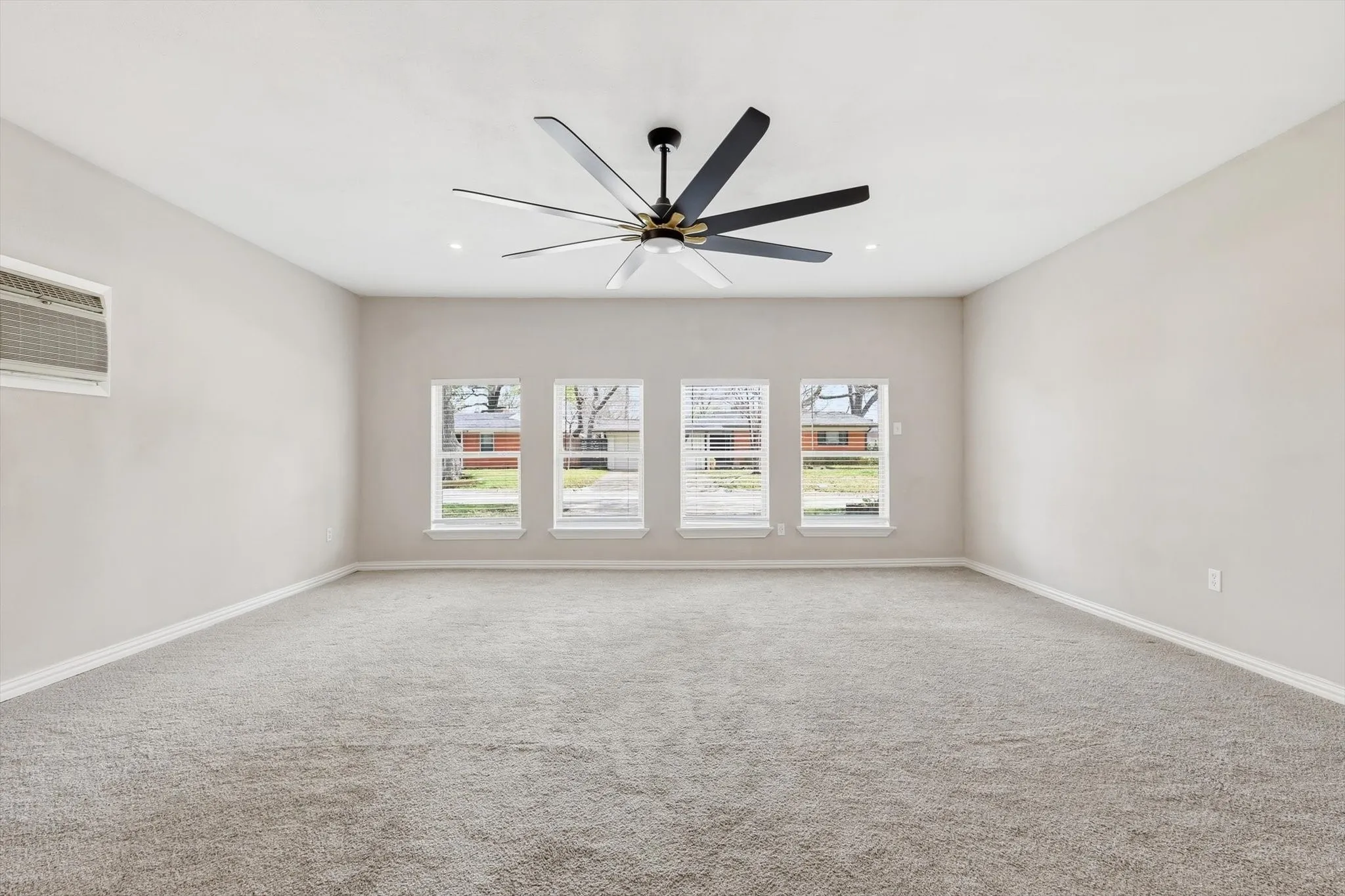 Unfurnished room with a ceiling fan and carpet