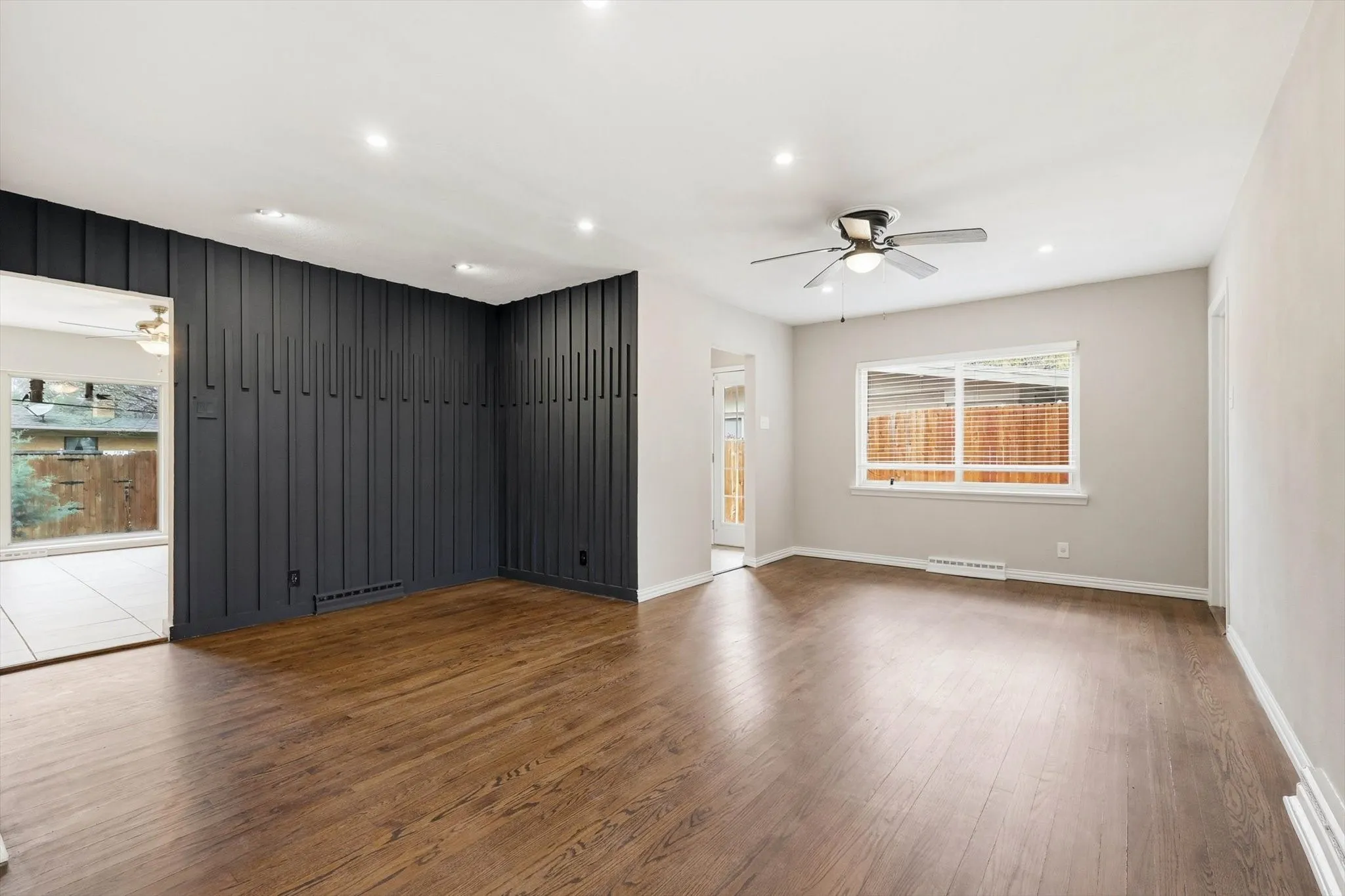 Spare room featuring a ceiling fan, dark wood finished floors, and recessed lighting
