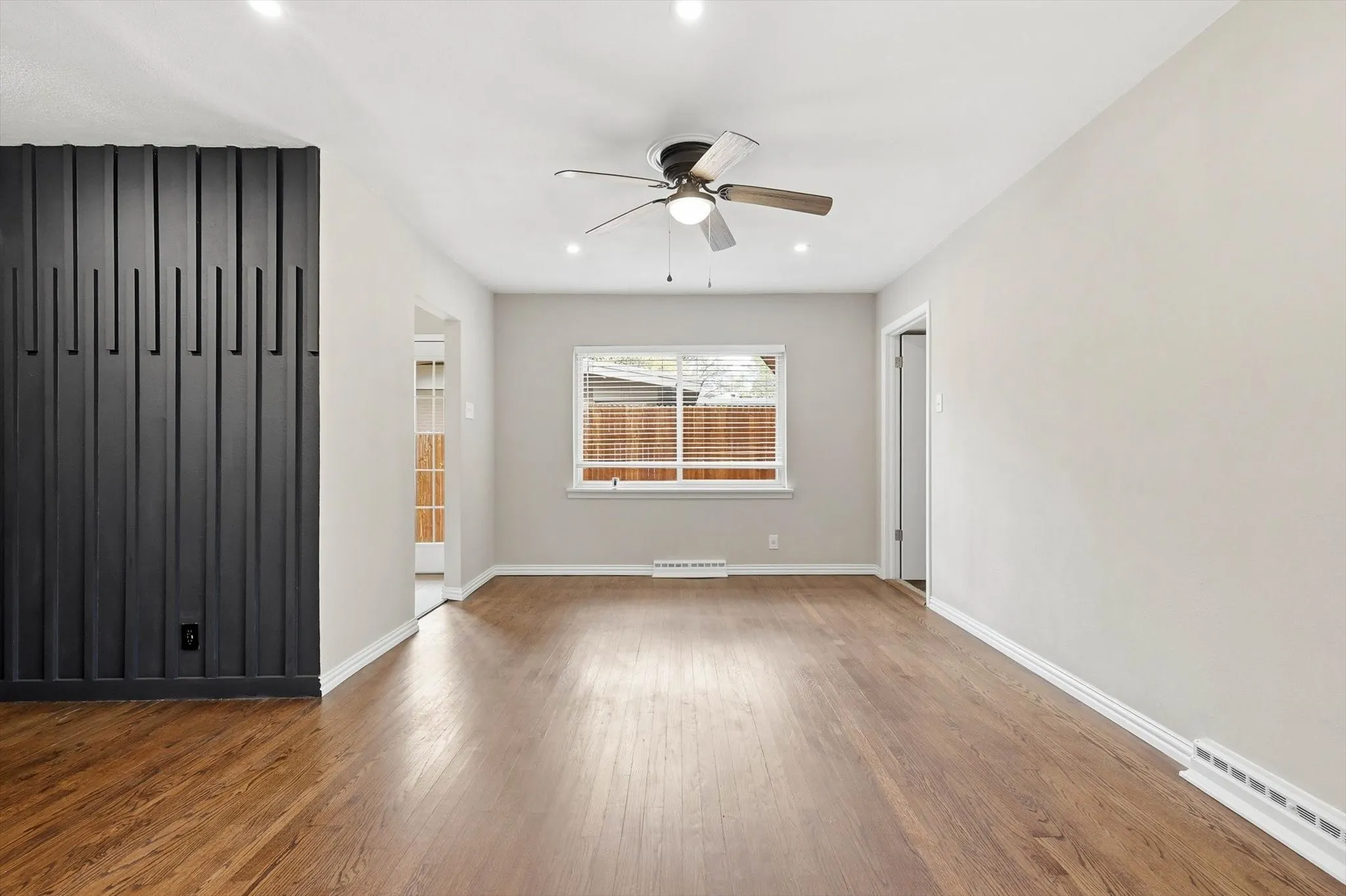 Empty room with a ceiling fan, wood-type flooring, and recessed lighting