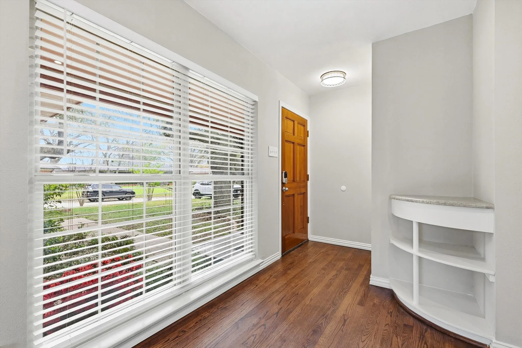 Entryway with wood finished floors and baseboards