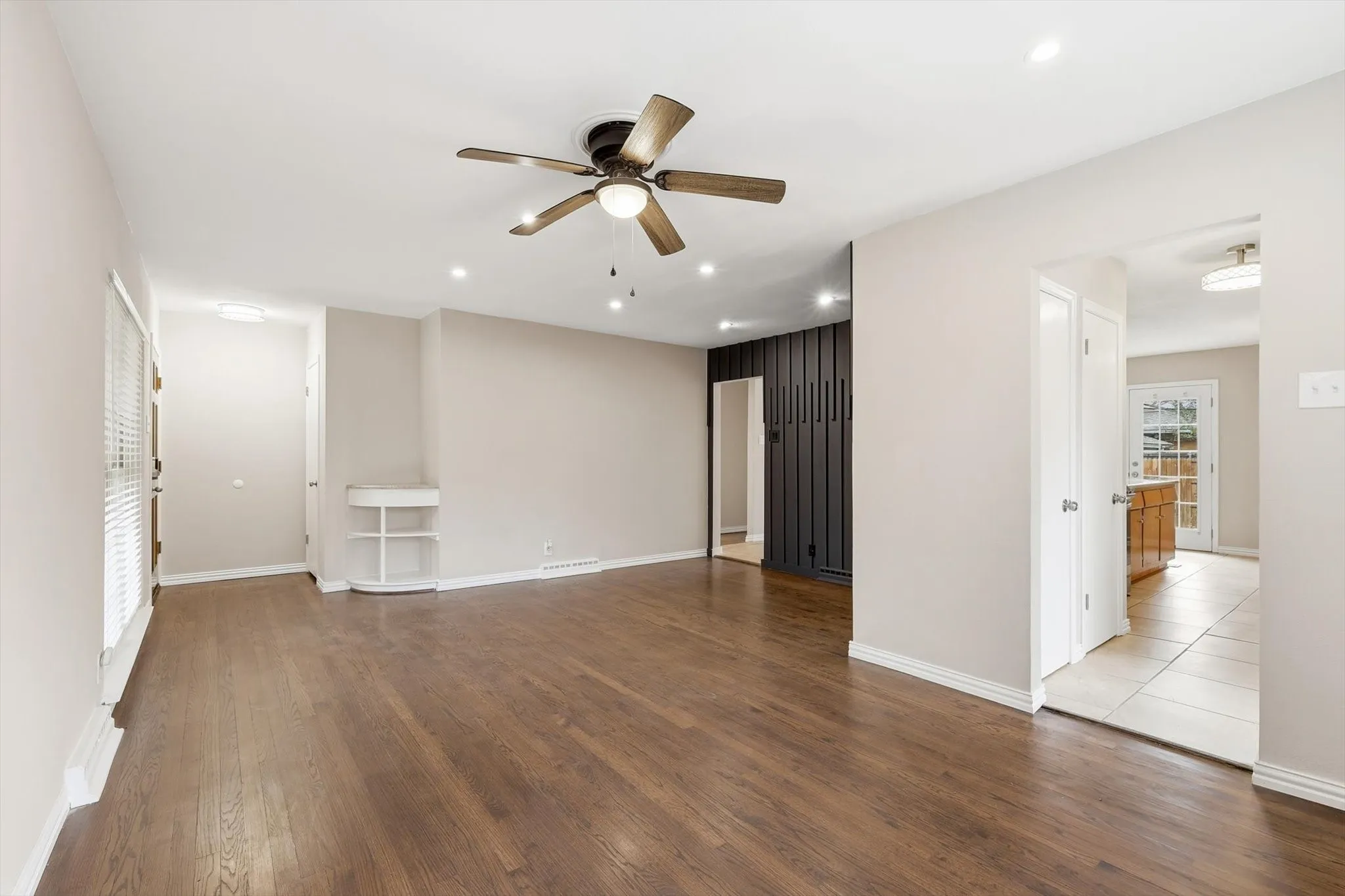 Spare room with ceiling fan, dark wood-style floors, and recessed lighting
