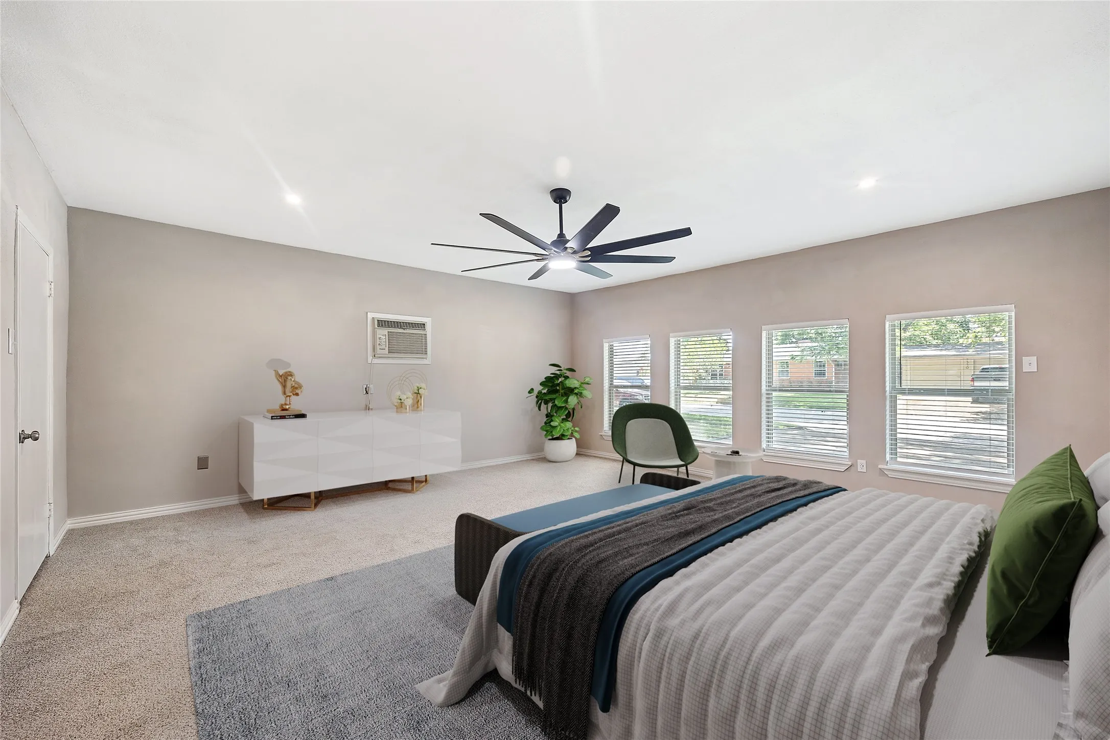Carpeted bedroom featuring baseboards and ceiling fan