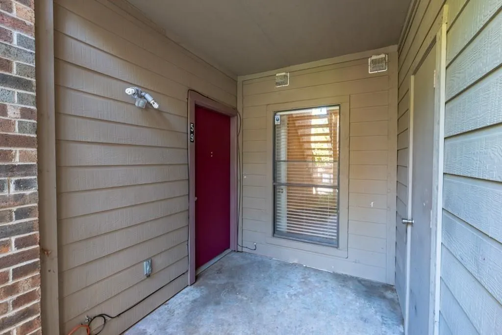 View of exterior entry with a patio area