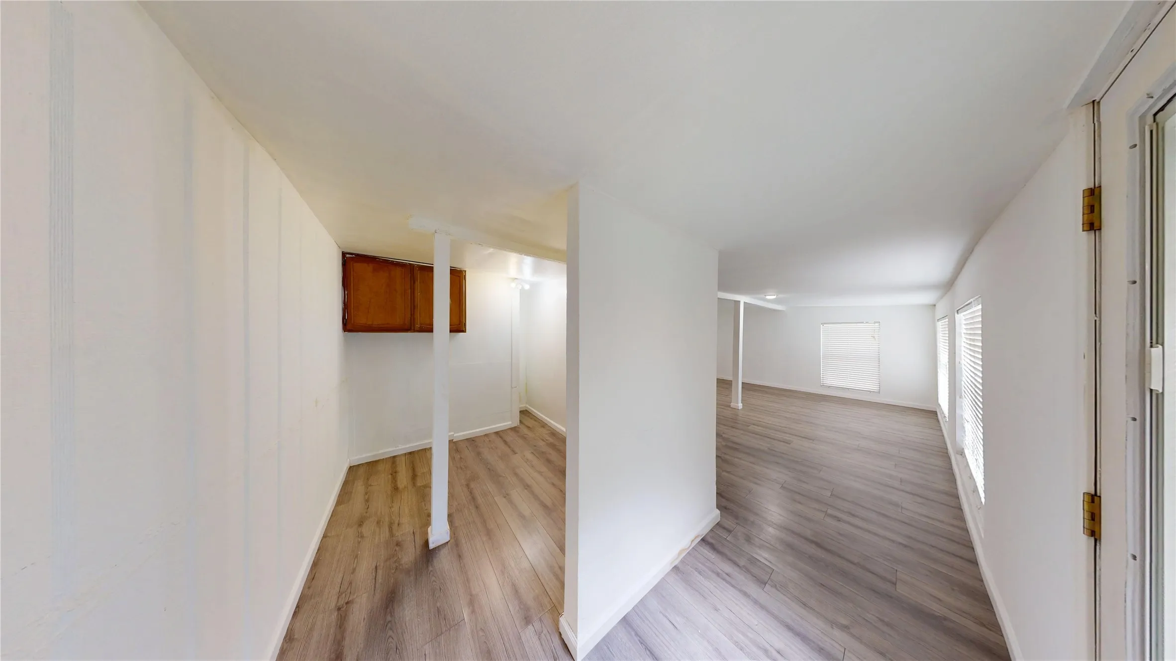 Hall with light wood-type flooring and baseboards