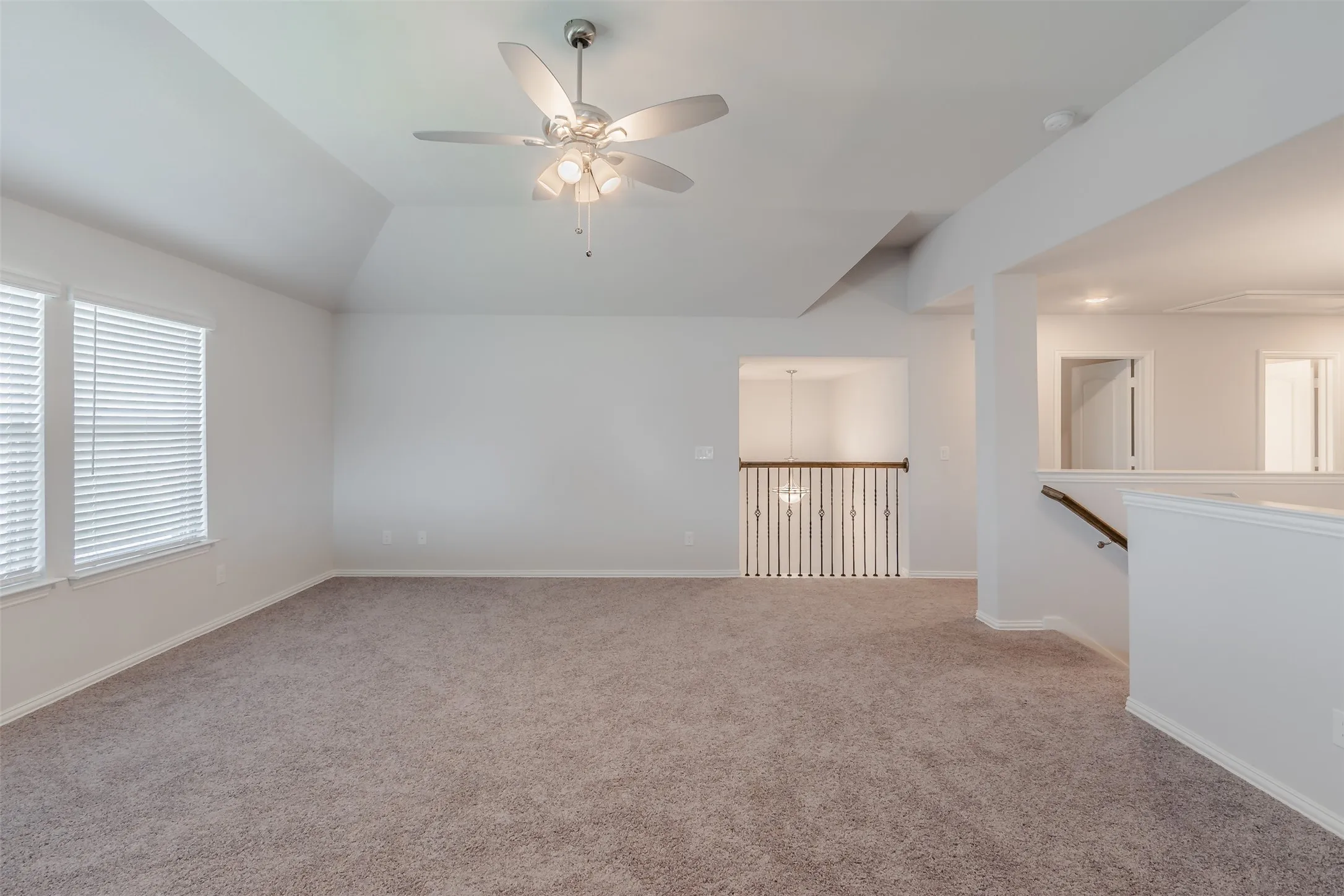 Unfurnished room with a ceiling fan, carpet, and lofted ceiling
