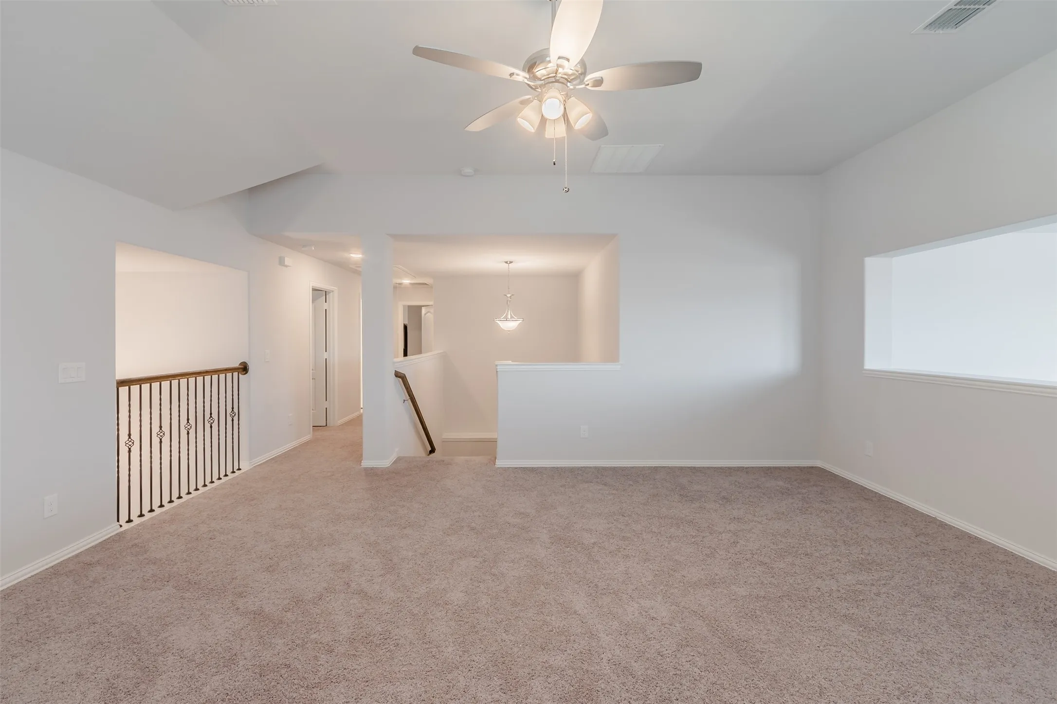 Spare room with a ceiling fan and carpet floors