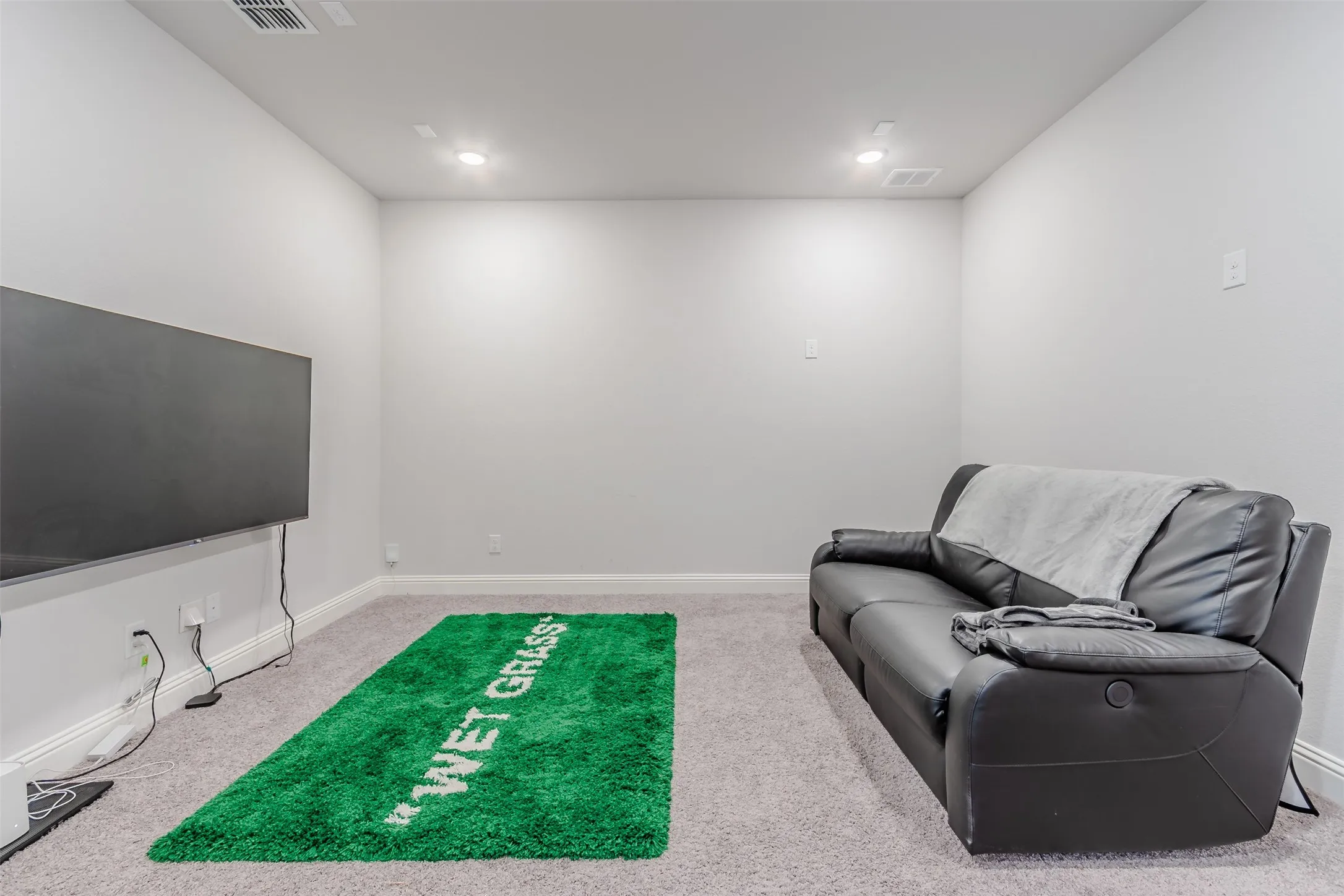 Sitting room featuring light colored carpet and recessed lighting