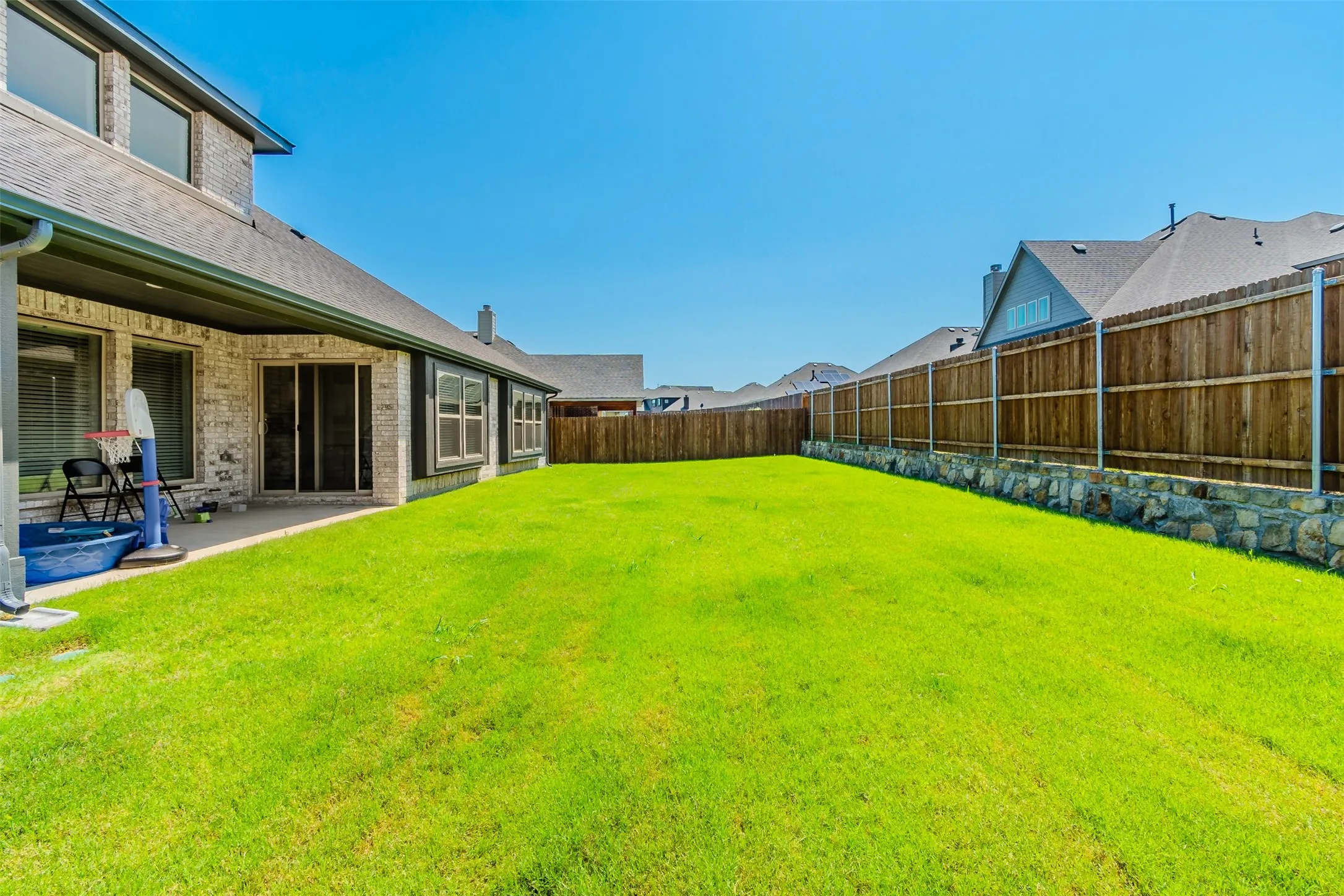 Fenced backyard with a patio area