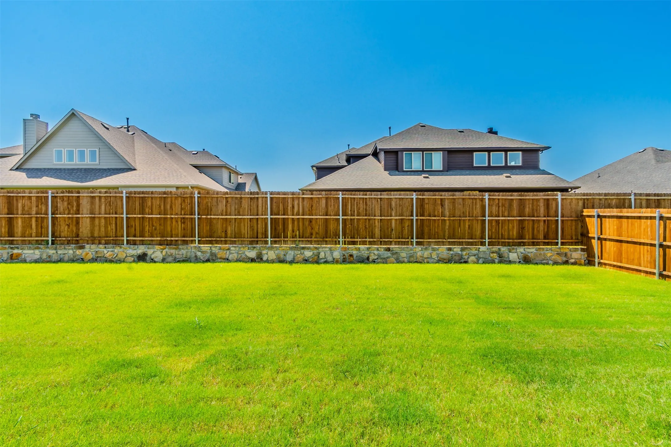 View of fenced backyard