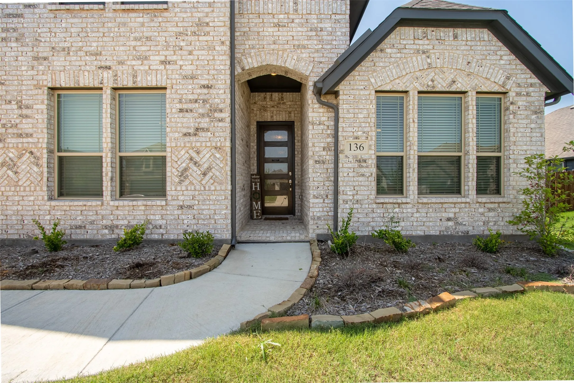 Property entrance featuring brick siding