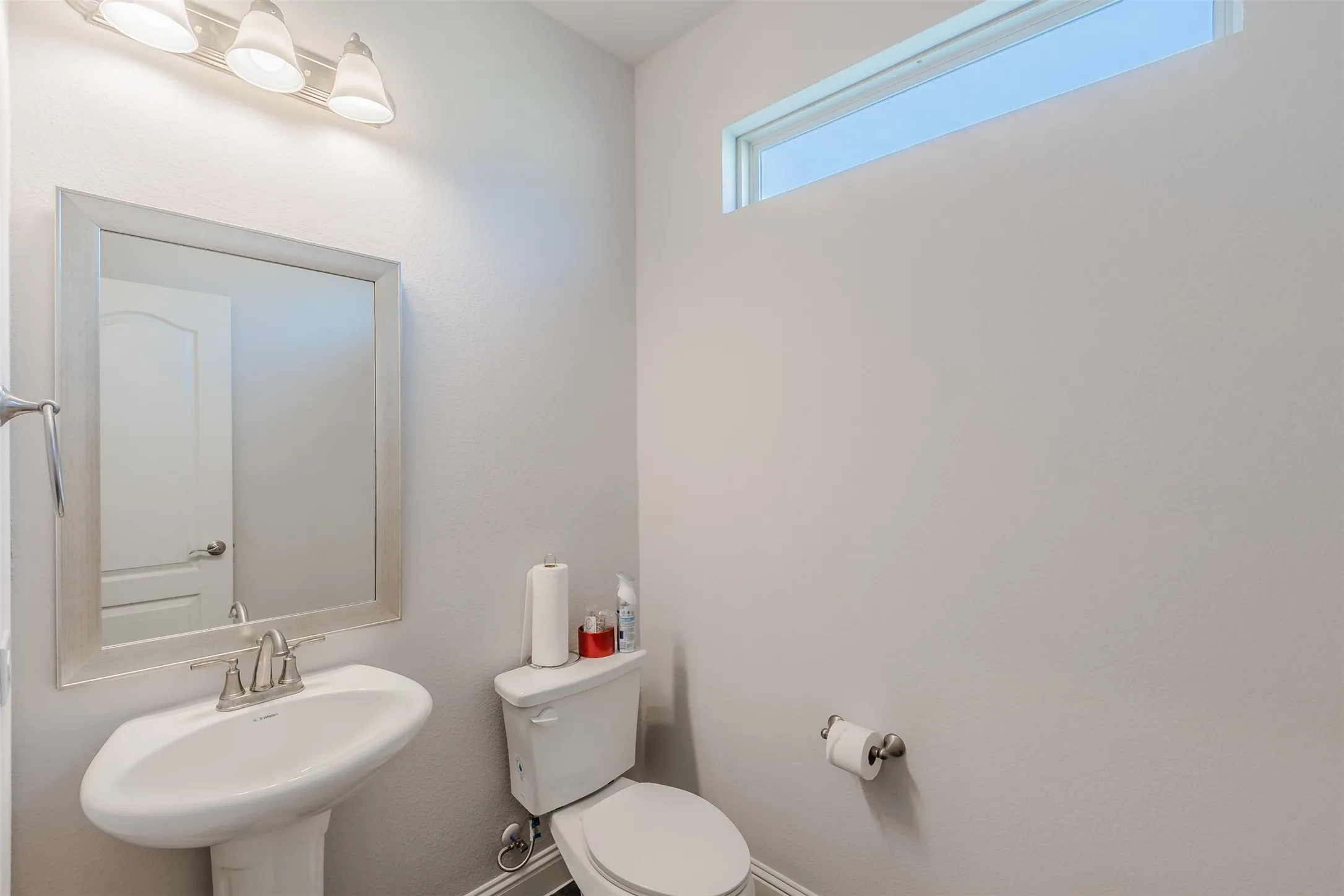 Bathroom with toilet and baseboards