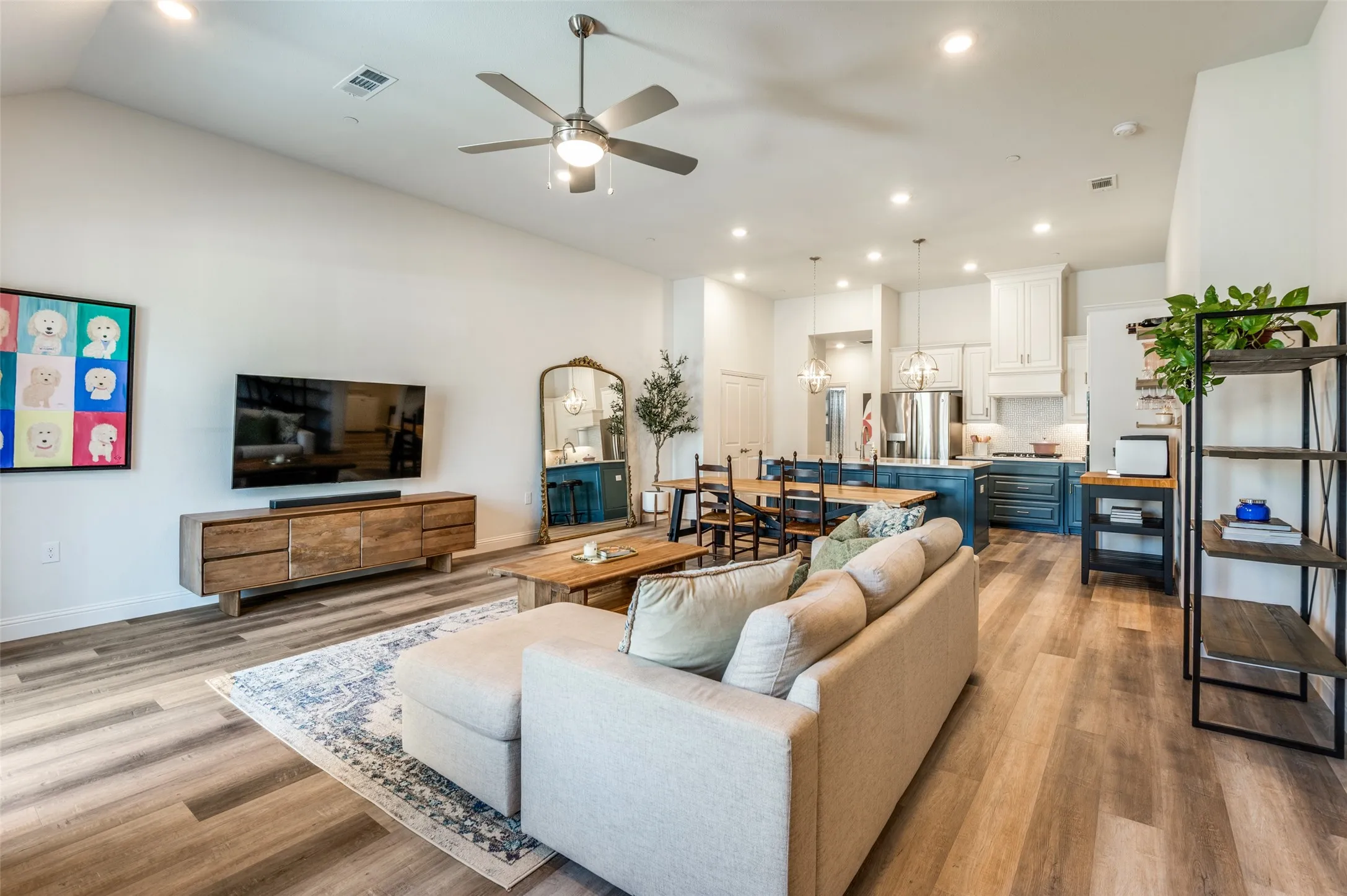 Spacious open-concept living and dining area with modern flooring and a comfortable layout. The space flows effortlessly into the kitchen, making it ideal for gatherings.