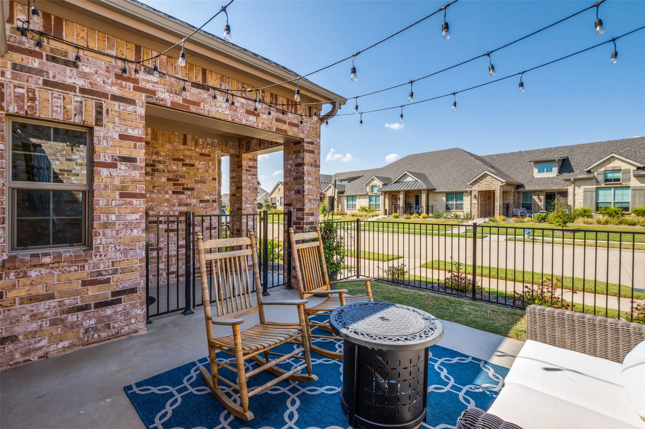 Front patio overlooking the beautifully maintained neighborhood, ideal for enjoying morning coffee or sunset views.