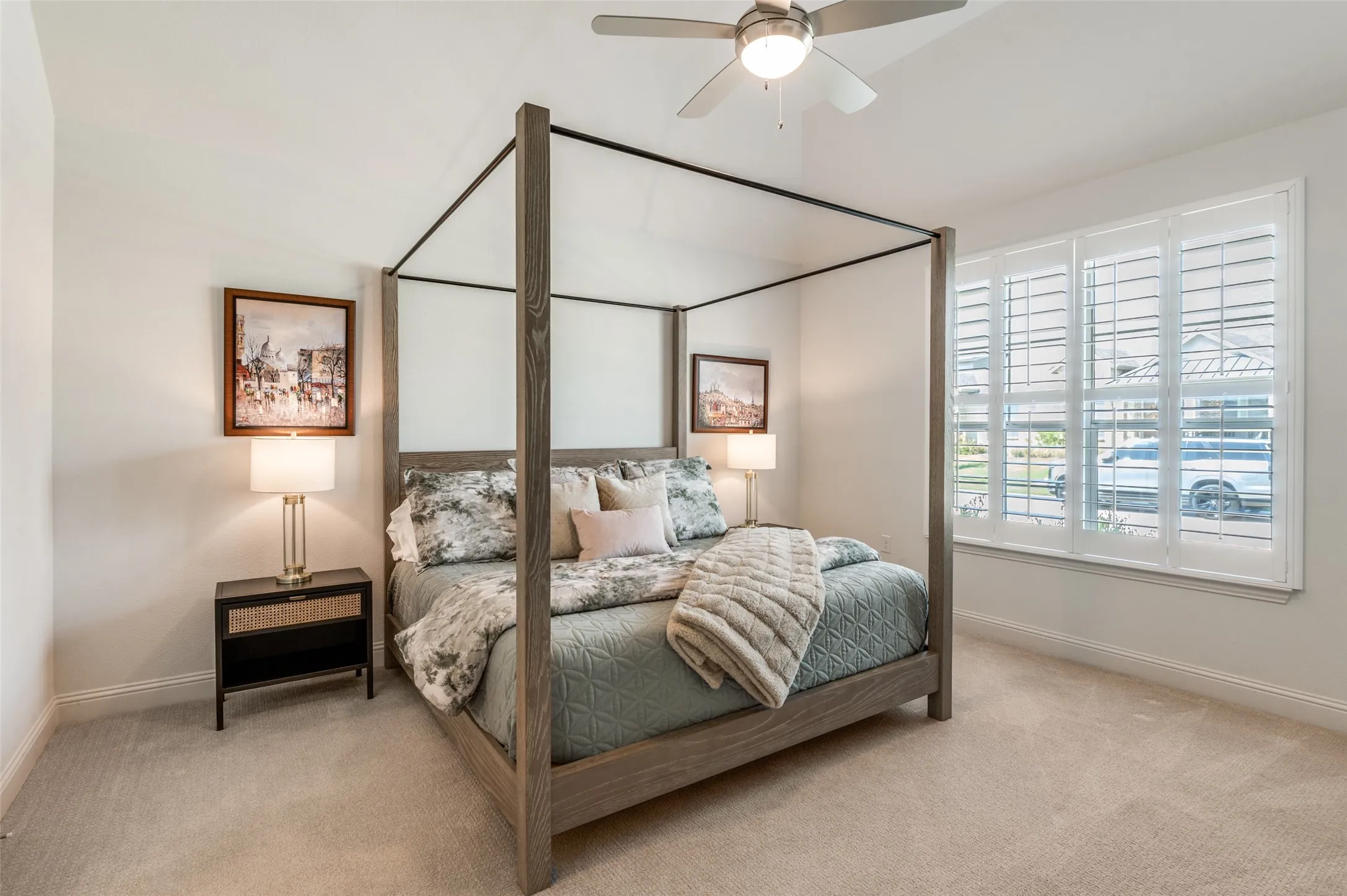 Spacious primary suite with vaulted ceilings, plush carpeting, and large windows that bring in abundant natural light. A peaceful retreat with plenty of room to relax.