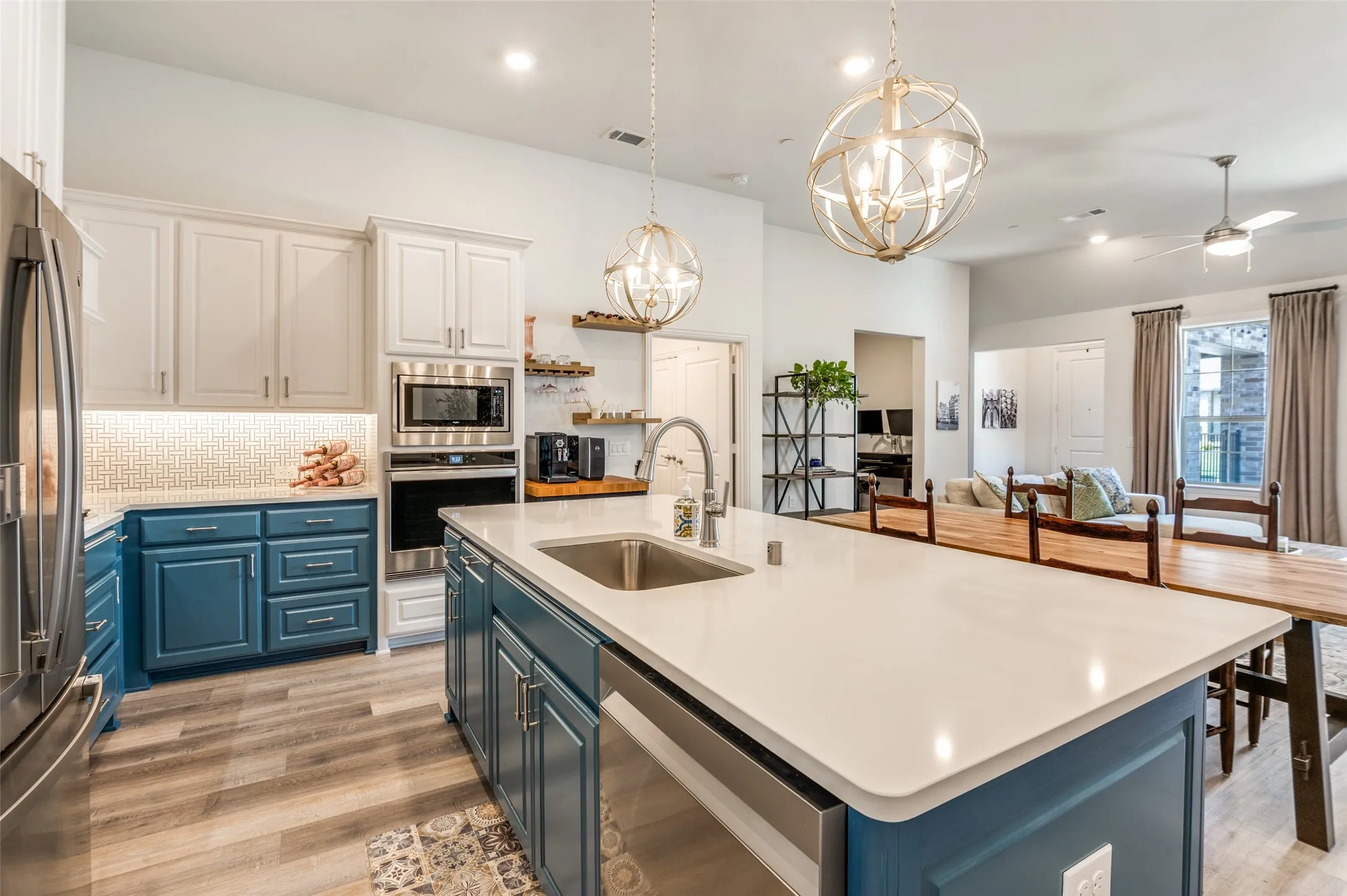 Oversized kitchen island with ample prep space and seating, ideal for casual dining or entertaining while enjoying the open-concept layout.